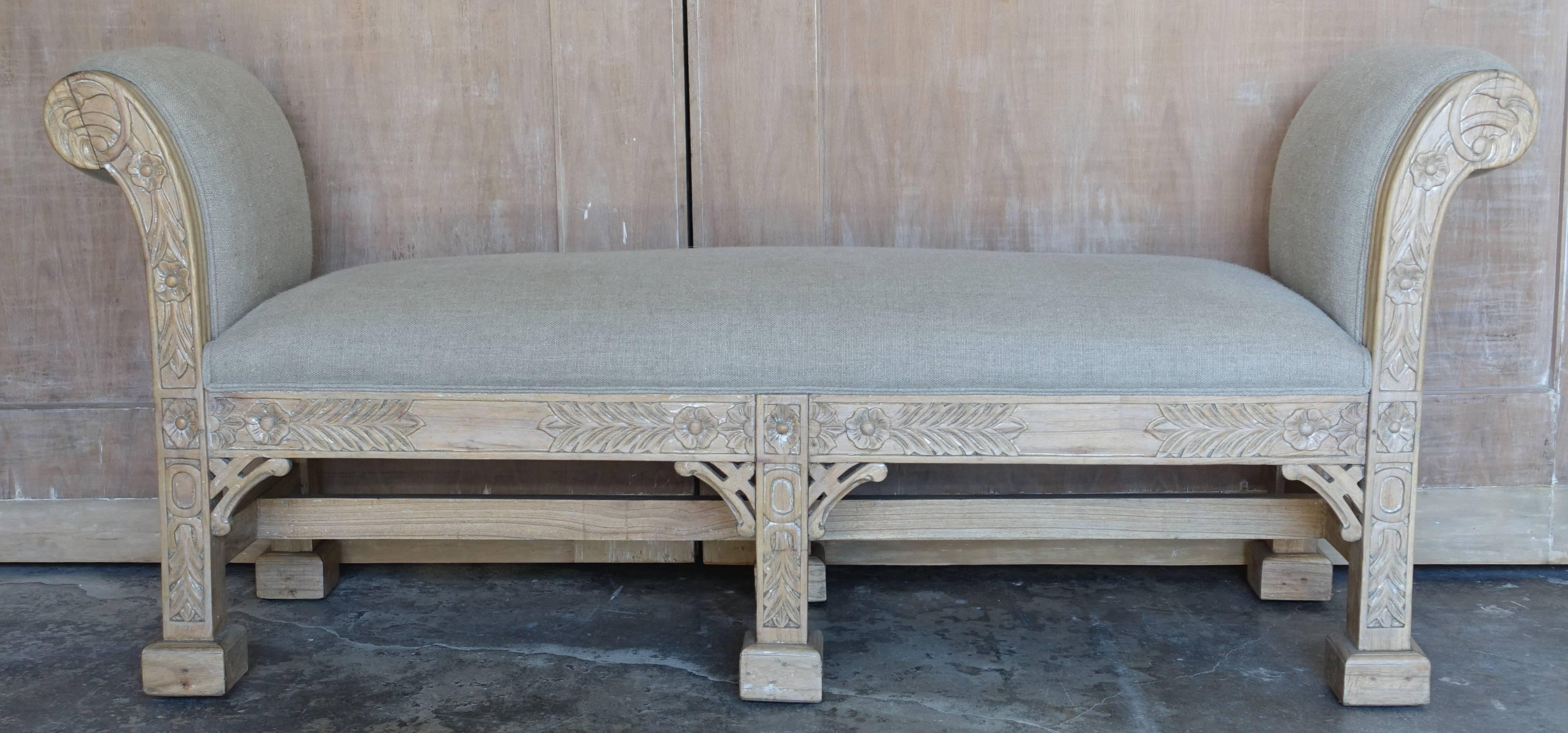 English chinoiserie style six-legged carved natural wood bench newly upholstered in Belgium linen with a self cord detail.