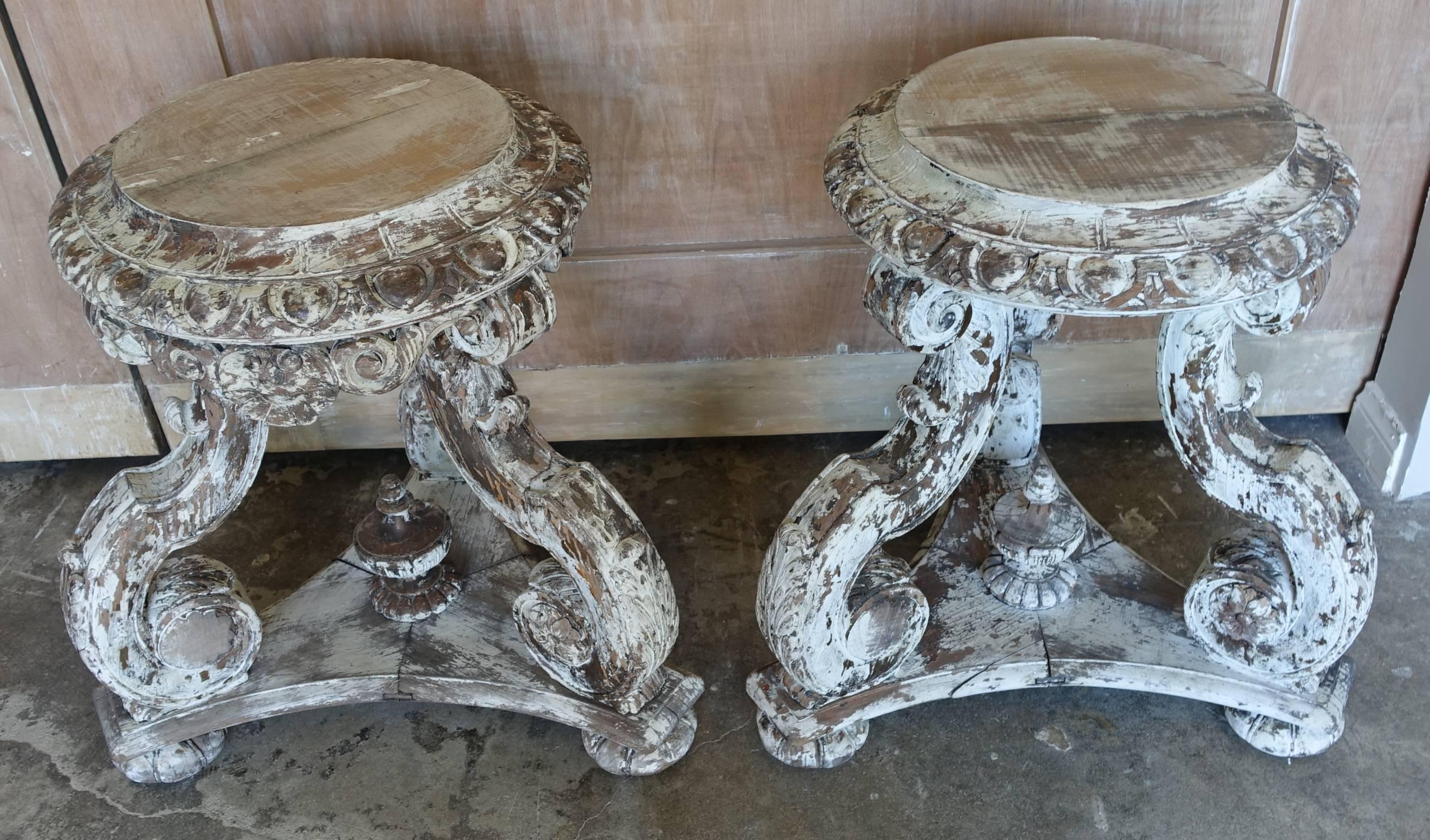 Set of four Italian carved painted tables/stools with center finials.