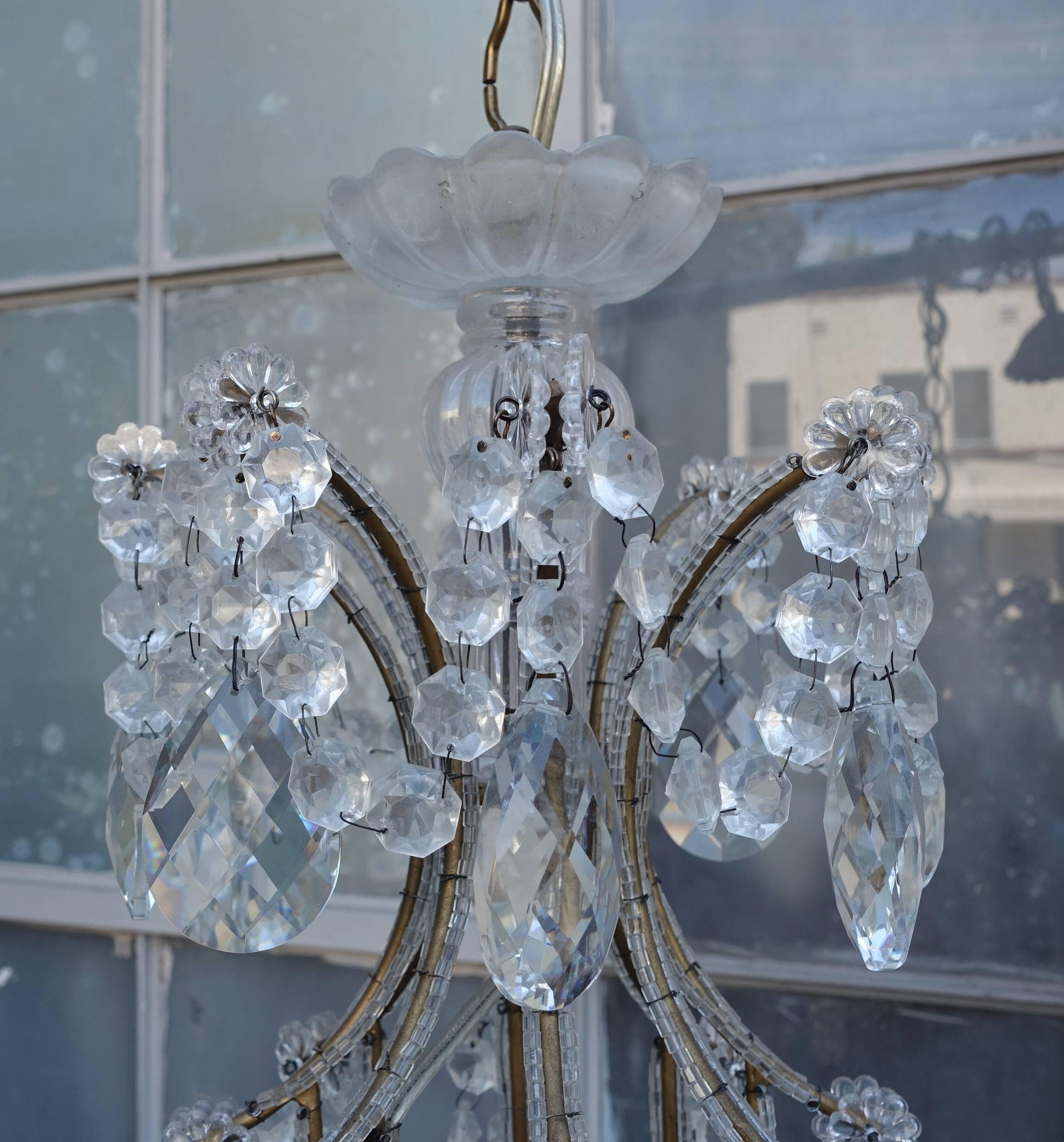 Eight-light Italian crystal beaded chandelier with giltwood bobeches. Newly rewired with drip wax candle covers. Chain and canopy included.