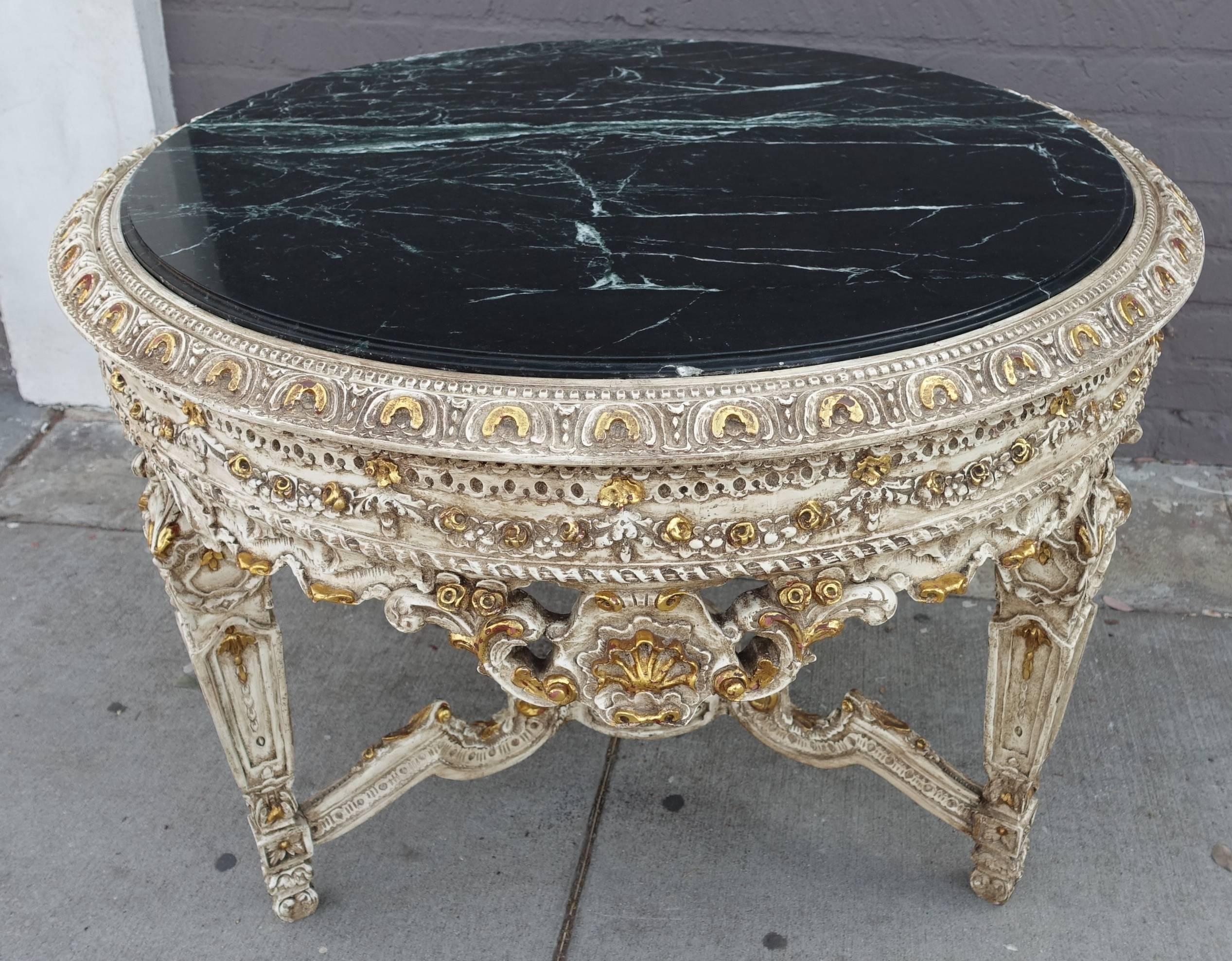 French carved wood painted and parcel-gilt center table with green marble top.