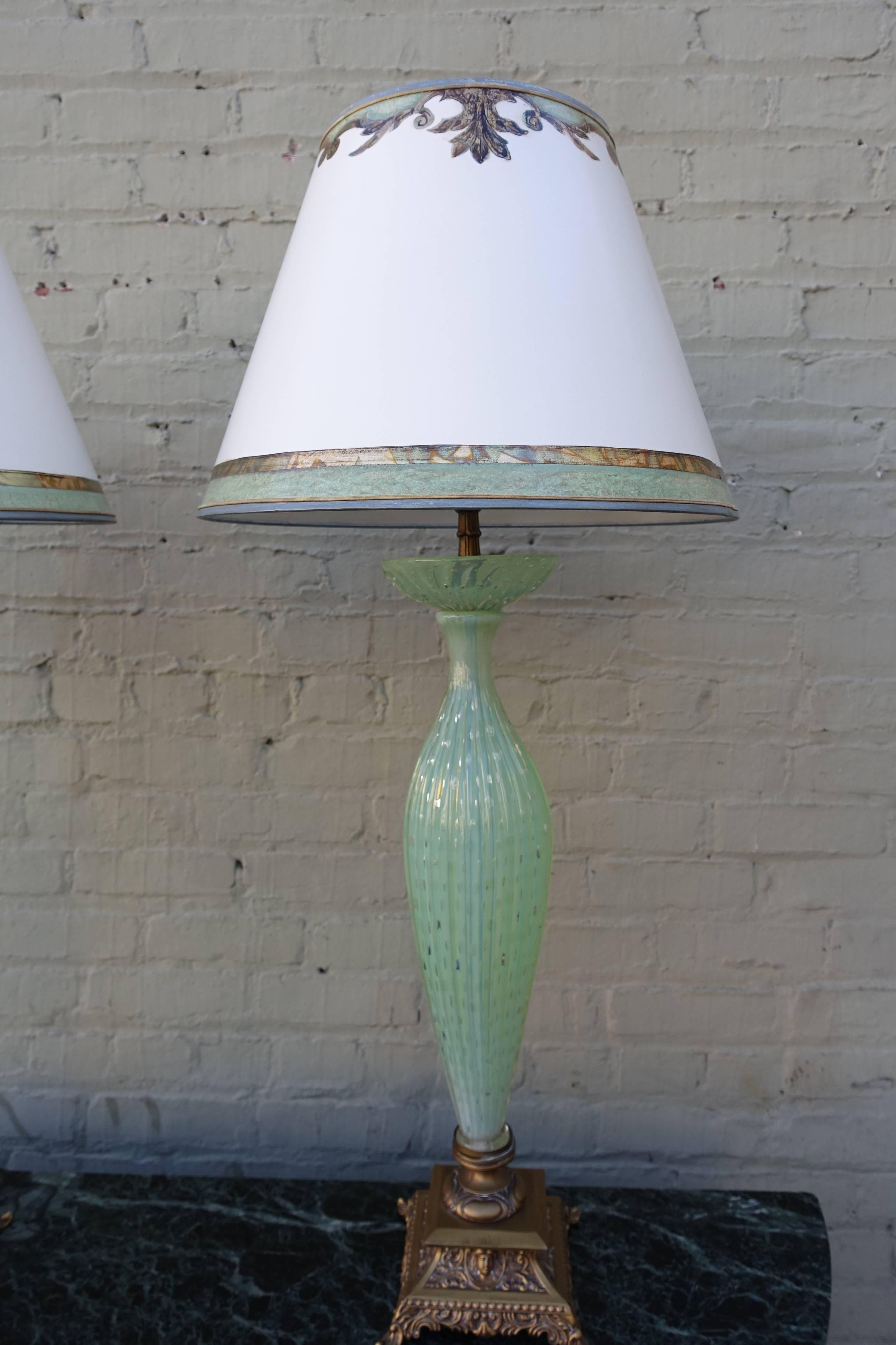 Pair of handblown sea foam green Murano glass lamps on gilt metal bases. The lamps are crowned with custom hand-painted parchment shades. Shade size: 9
