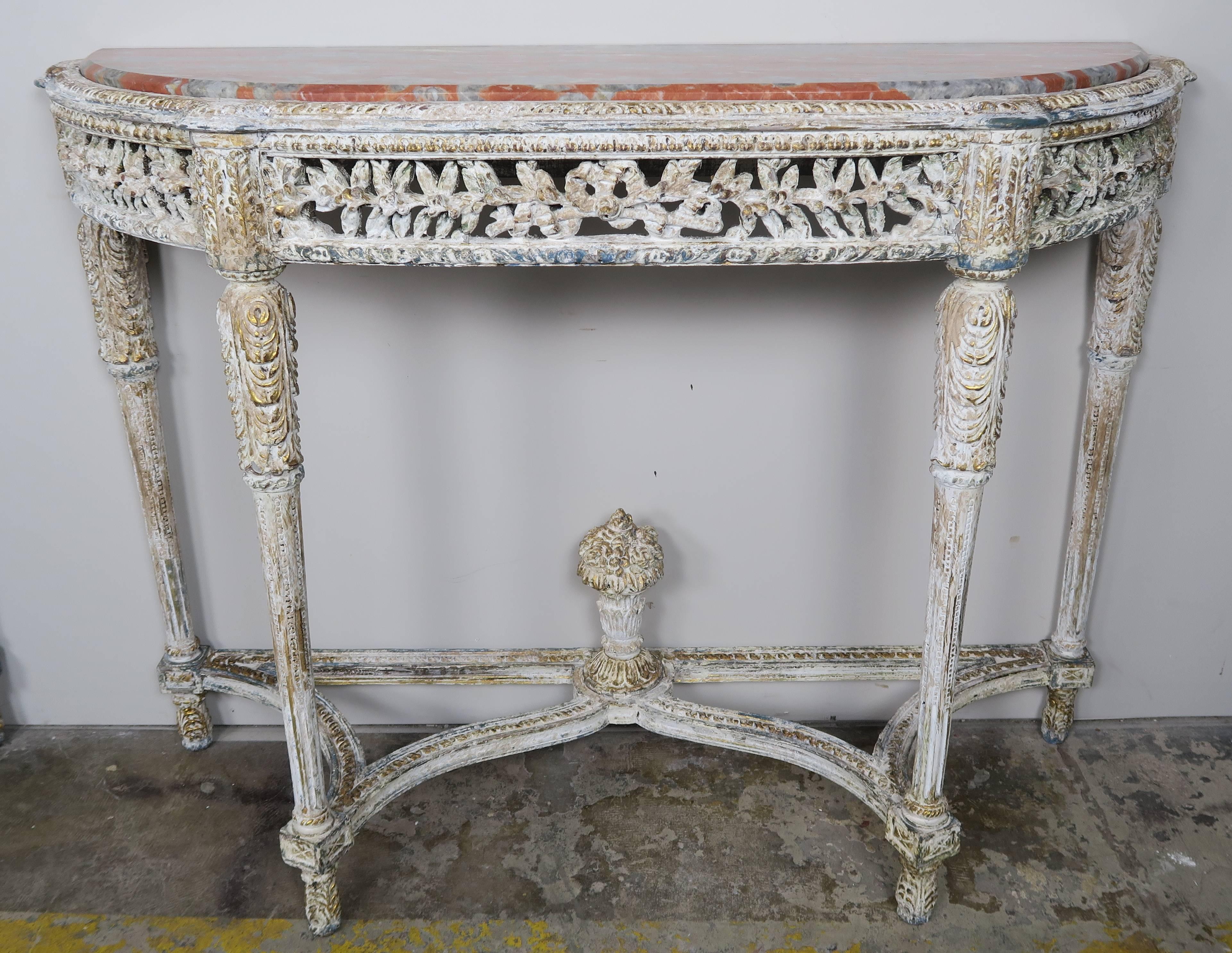 Louis XVI style painted console with marble top. The console stands on four straight legs that meet at a centre floral finial. Finely carved apron depicting leaves. Rust and grey colored inset marble tops.