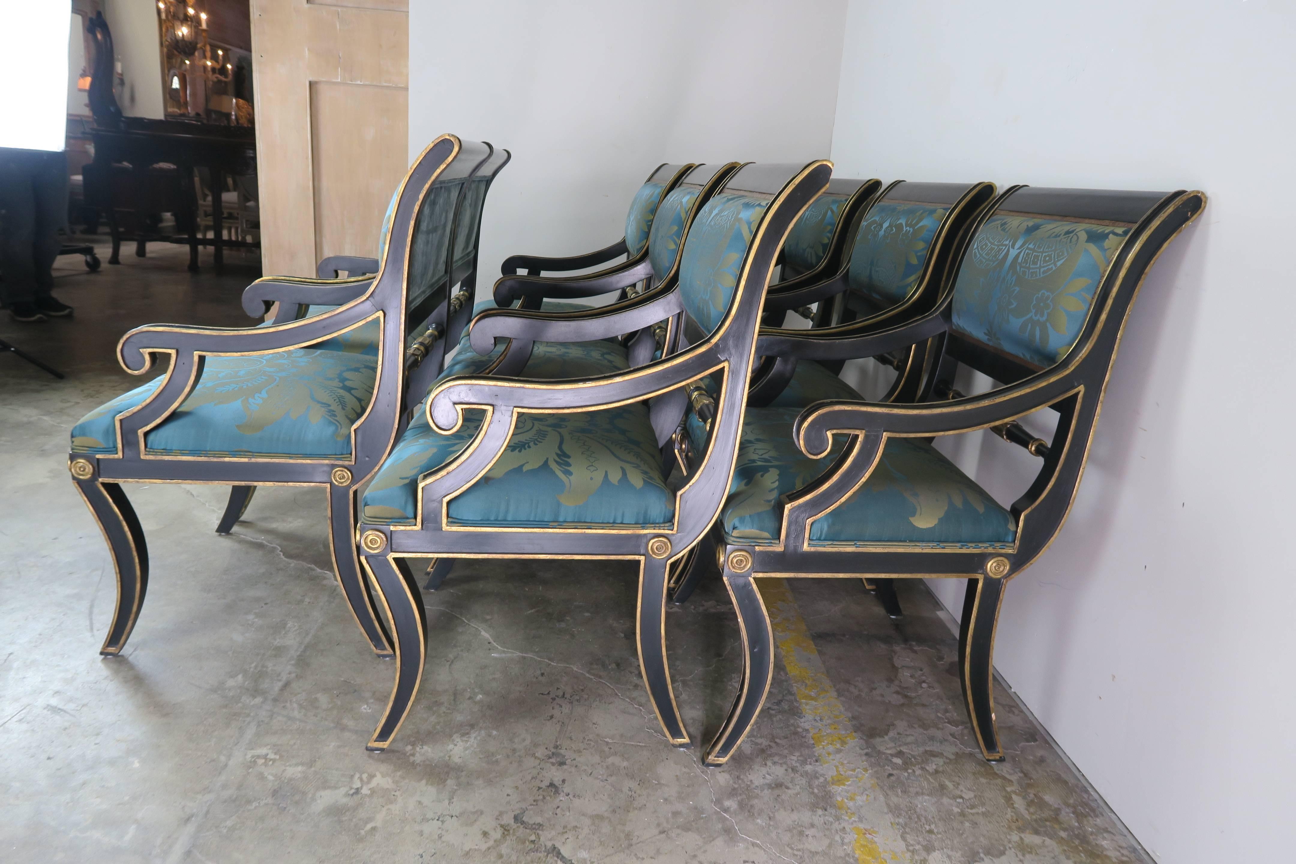 Set of Eight Italian Regency black lacquered and gold gilt armchairs newly upholstered in a high-end silk damask with aqua colored silk velvet backs. A beautiful set that is ready to install.