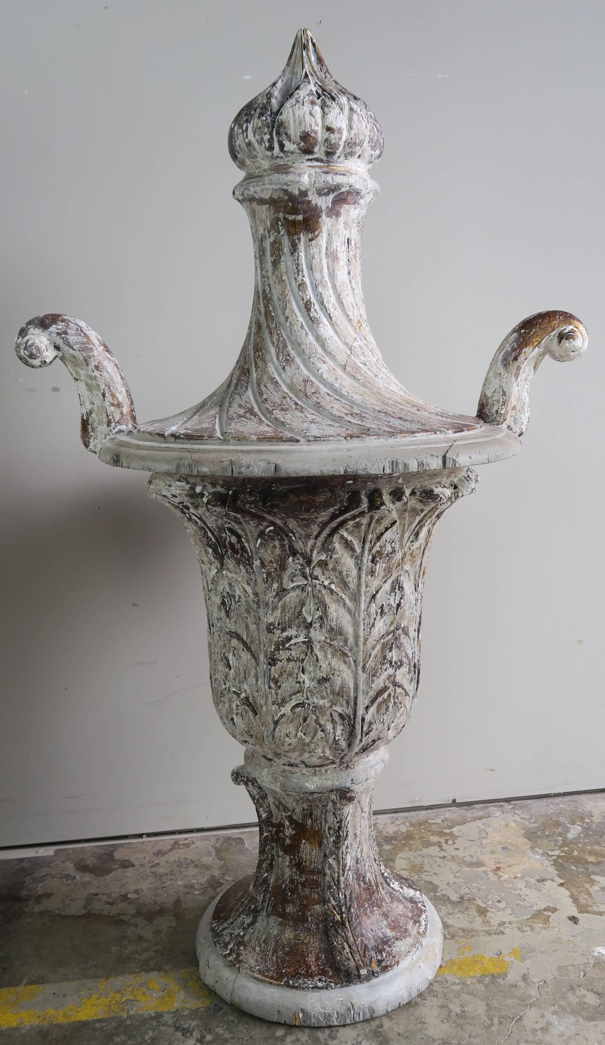 Pair of carved wood Italian painted urns with beautiful carved details including flamed tops.