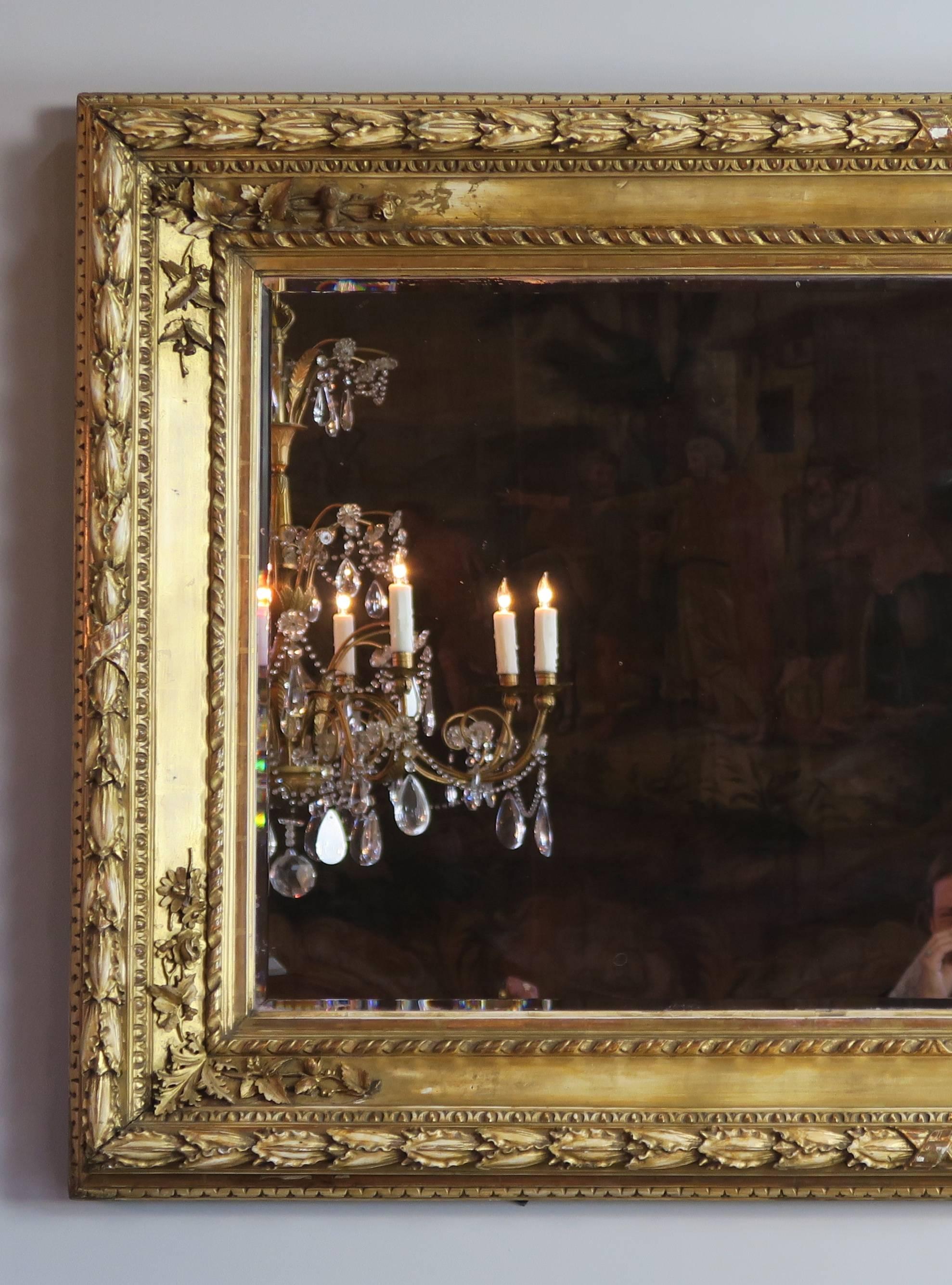 19th century Italian giltwood mirror with intricately carved details throughout. Mirror has a 1