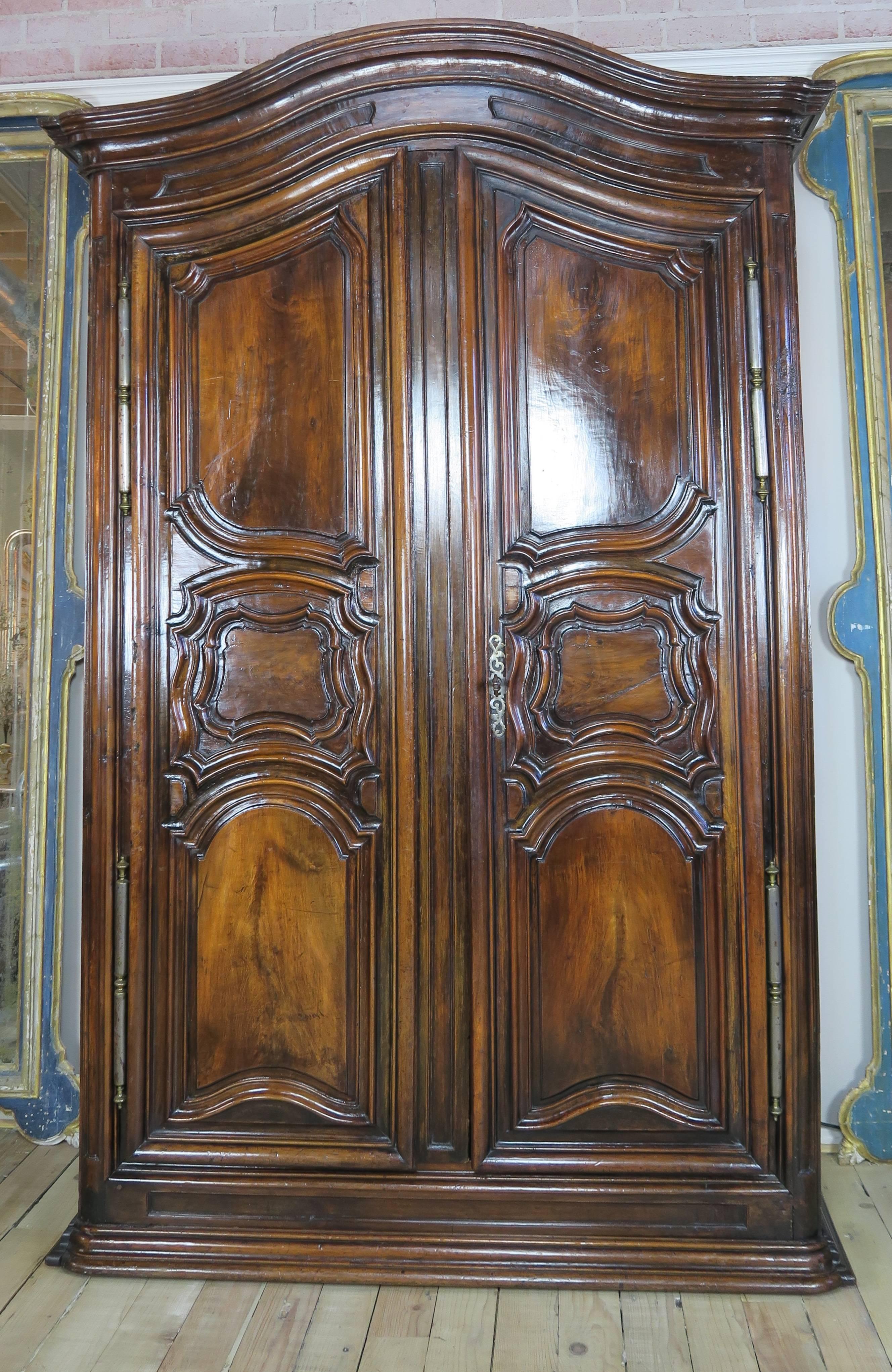 Mid-18th century carved French walnut armoire with original working key-most beautiful and intricate key and lock I have even seen and original handmade hardware with fleur di Lis. Beautiful patina.