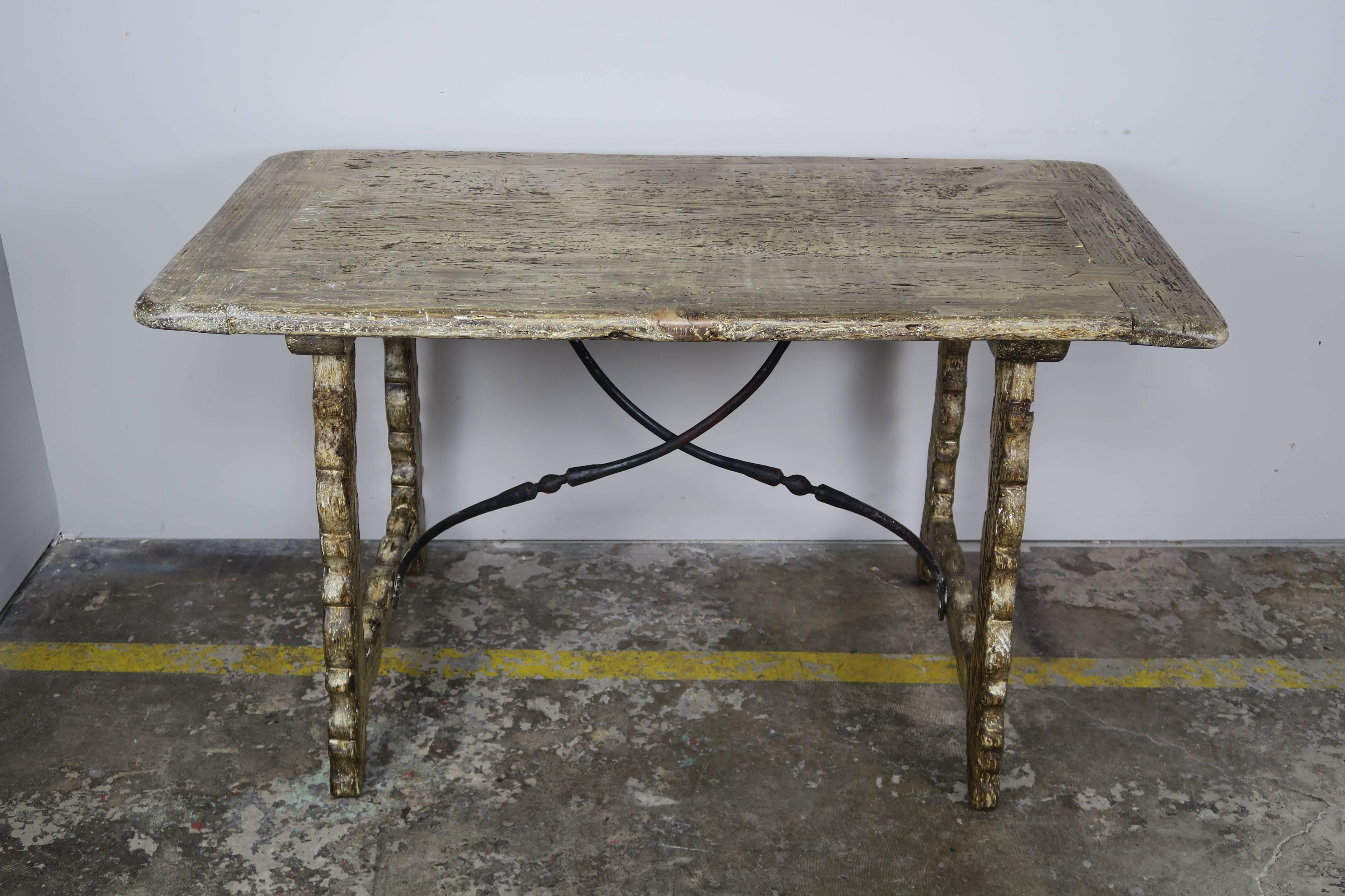 19th century Spanish table with iron stretcher. Beautiful worn finish.