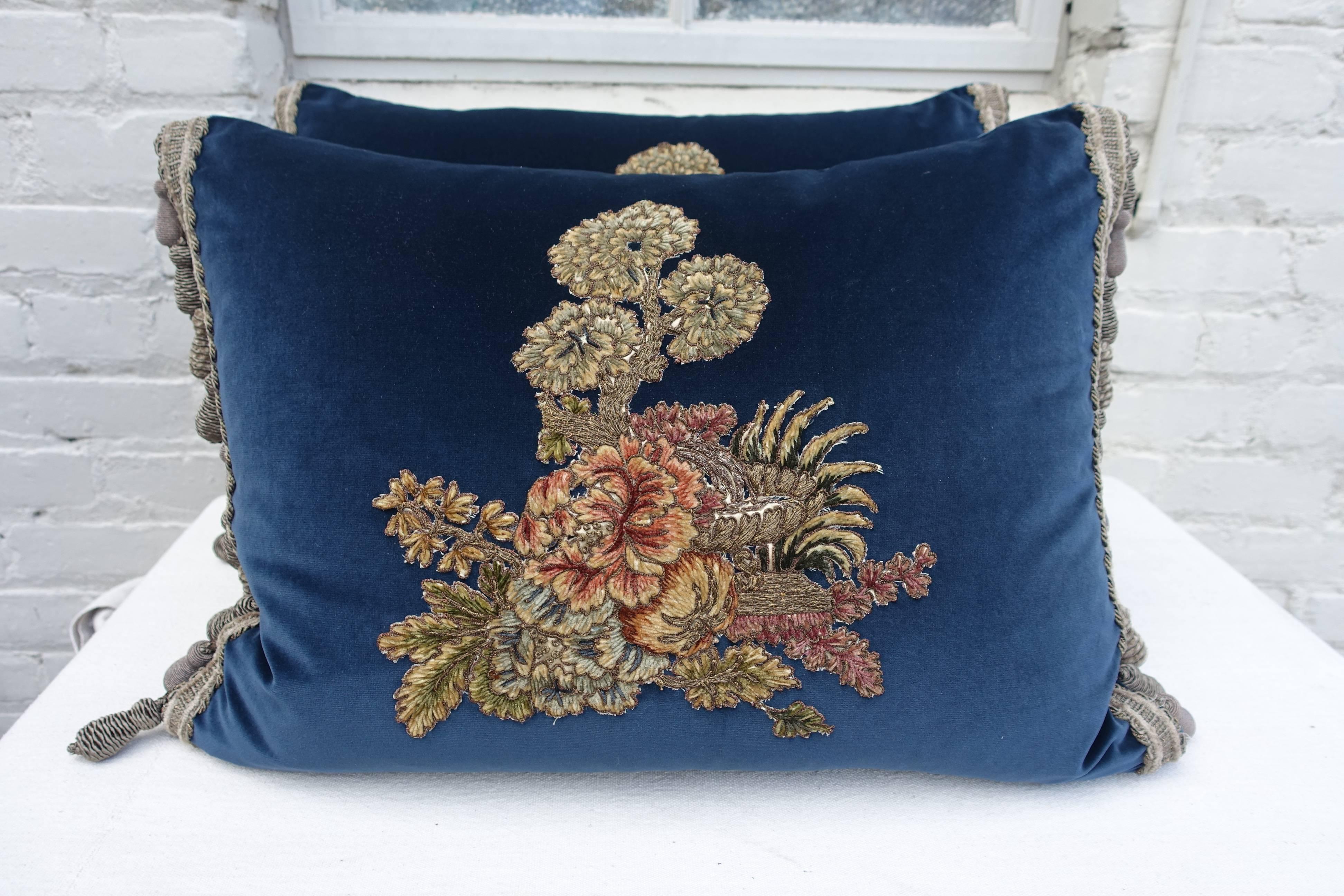 Pair of custom pillows made with 19th century French metallic and chenille handmade embroidered textiles hand applied on contemporary deep blue velvet and finished with handmade tassel fringe at both sides. Down inserts. Sewn shut.