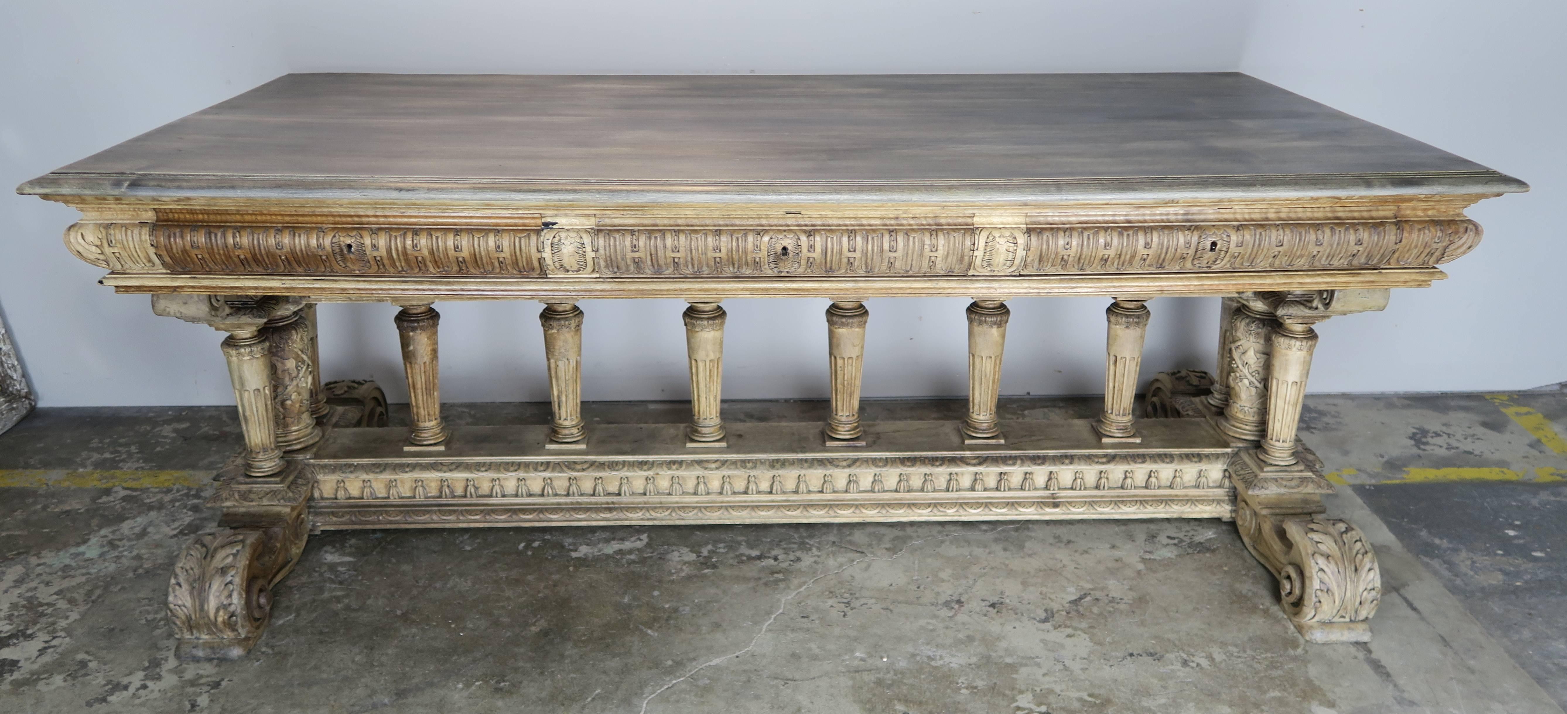 19th century ornately carved Italian Renaissance style table with three drawers.