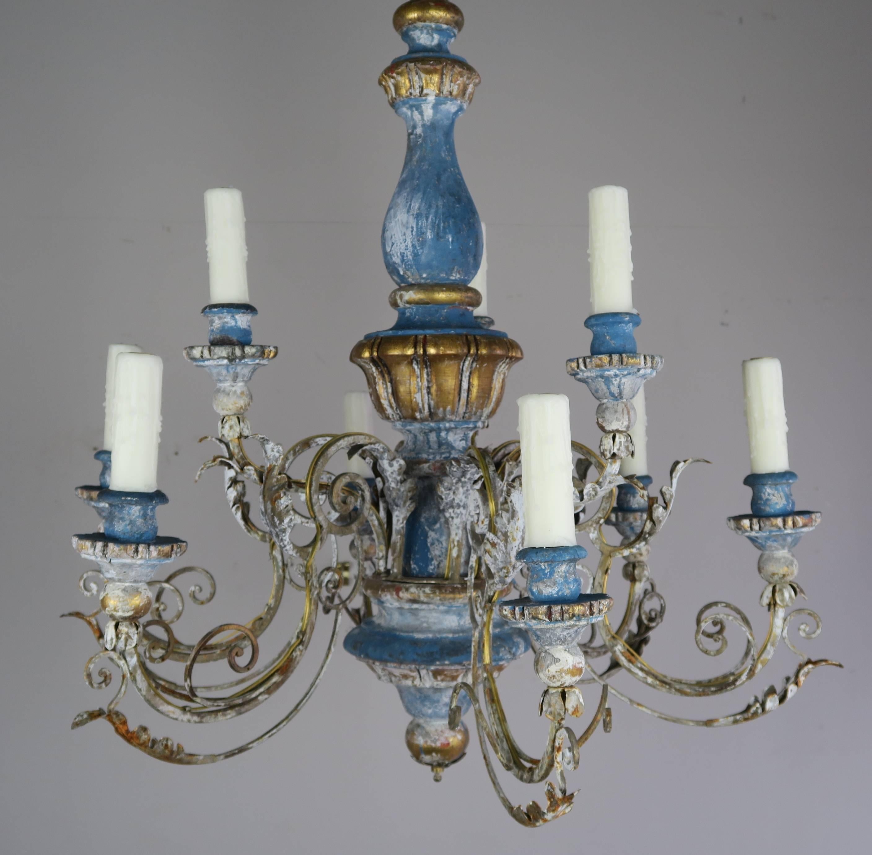 Italian blue painted and parcel-gilt chandelier. The metal arms are detailed with acanthus leaves and end in wood bobeches. The chandelier is newly rewired with drip wax candle covers. Chain and canopy included.