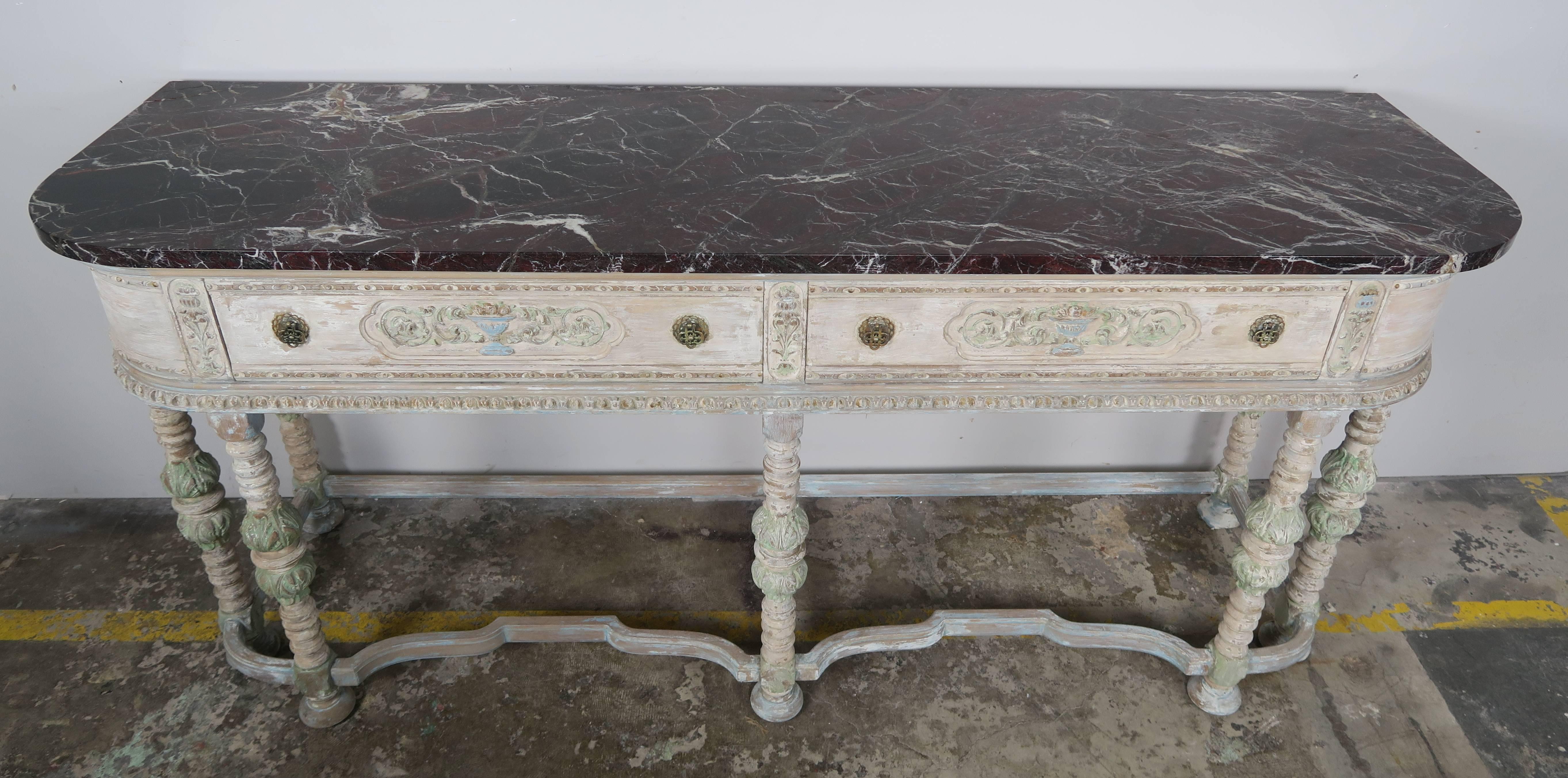 Louis XVI style French painted sideboard with two large drawers and original brown marble top with white veins. The carved wood sideboard stands on seven straight legs with carved acanthus leaves and bun feet. The legs are attached by bottom