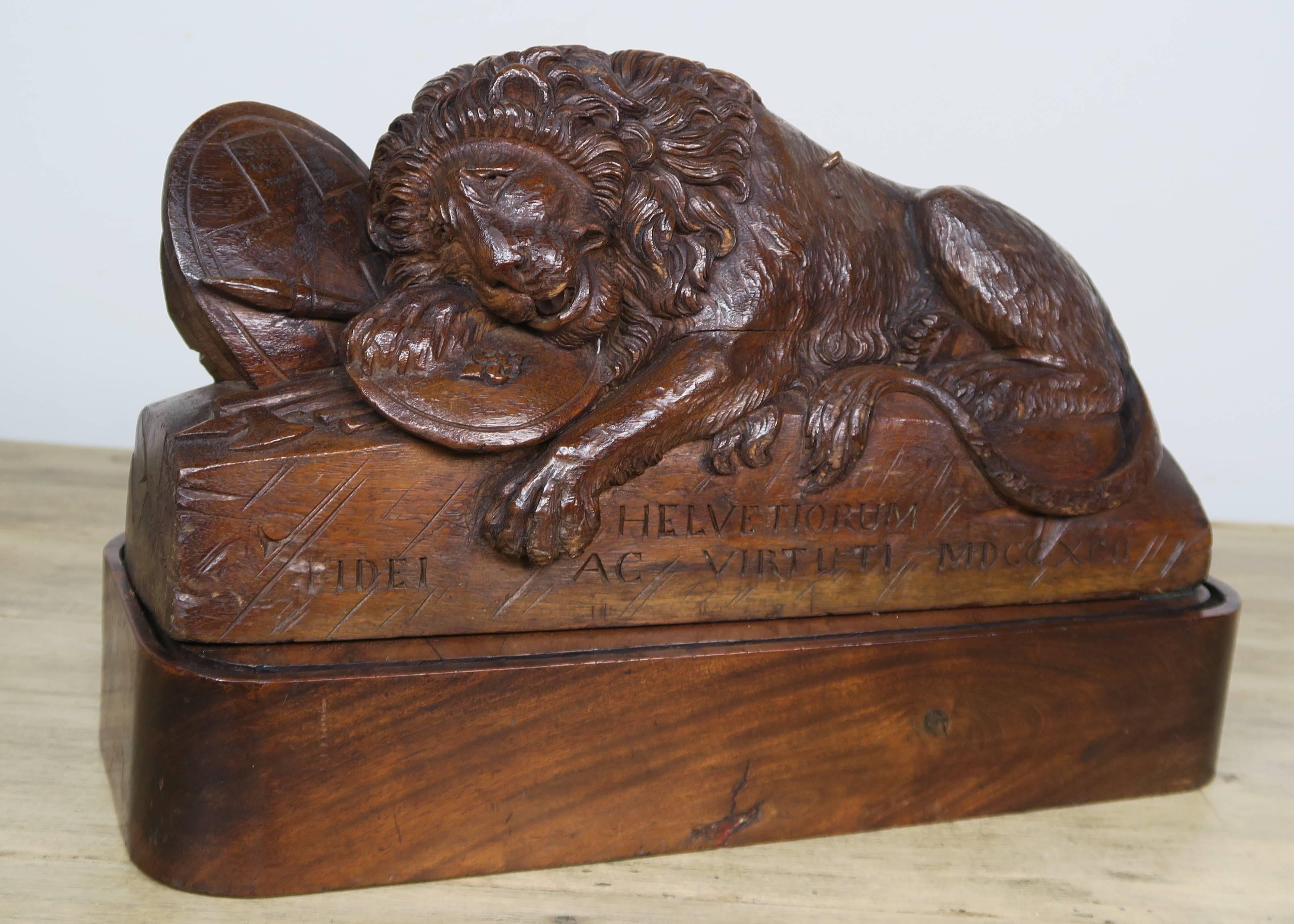 Carved wood lion with placque with Latin inscription that reads, when translated: 