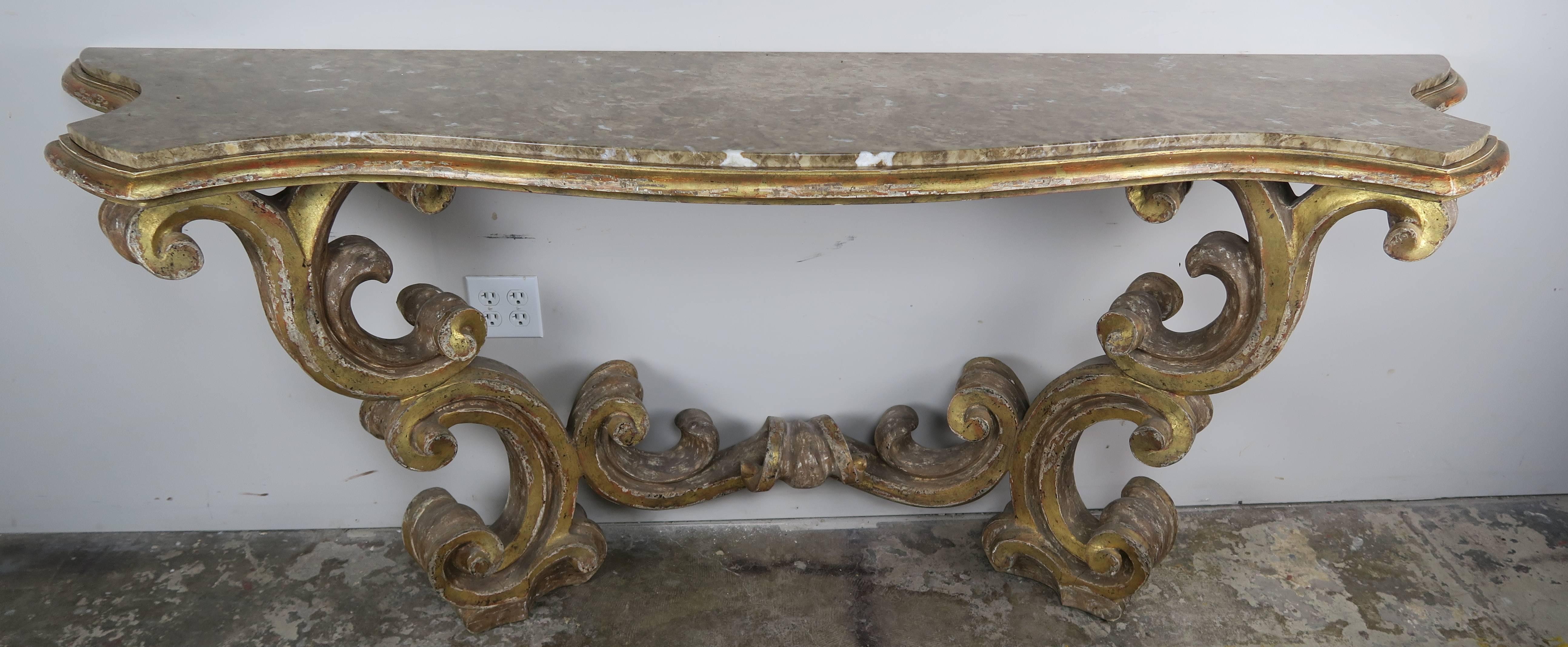Italian Baroque style giltwood carved console with inset marble top.