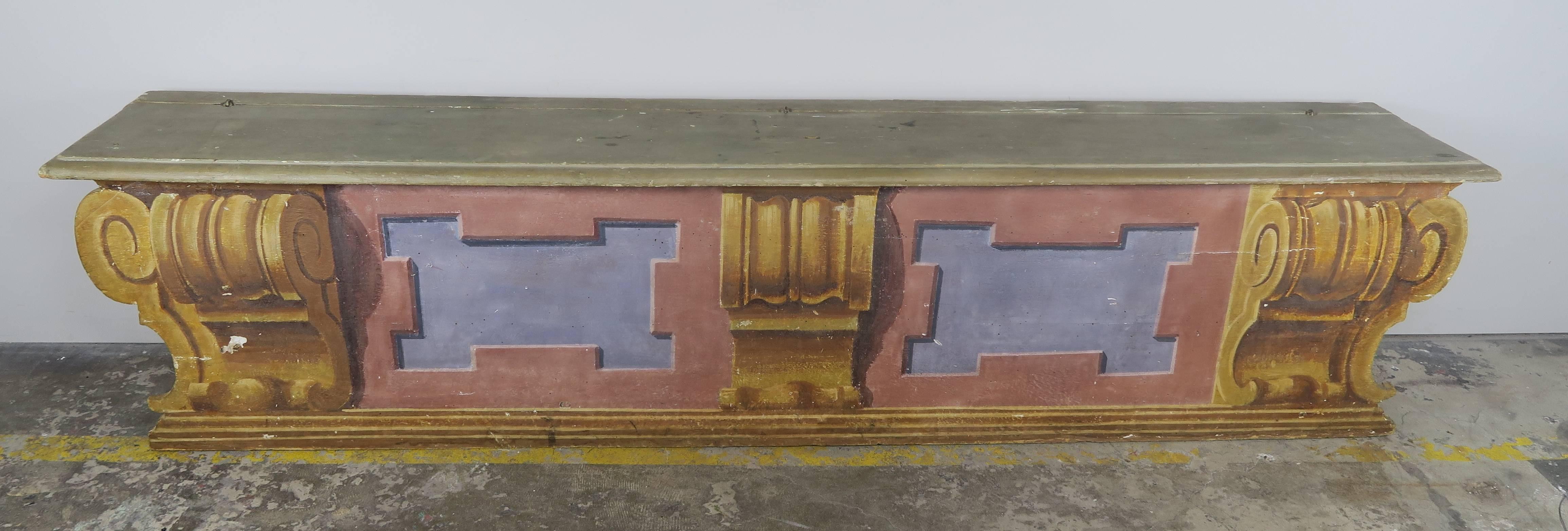 19th century Italian neoclassical style painted wood bench. There is storage underneath the top as depicted in photos. The bench is decorated with blue square panels surrounded by gold corbels.