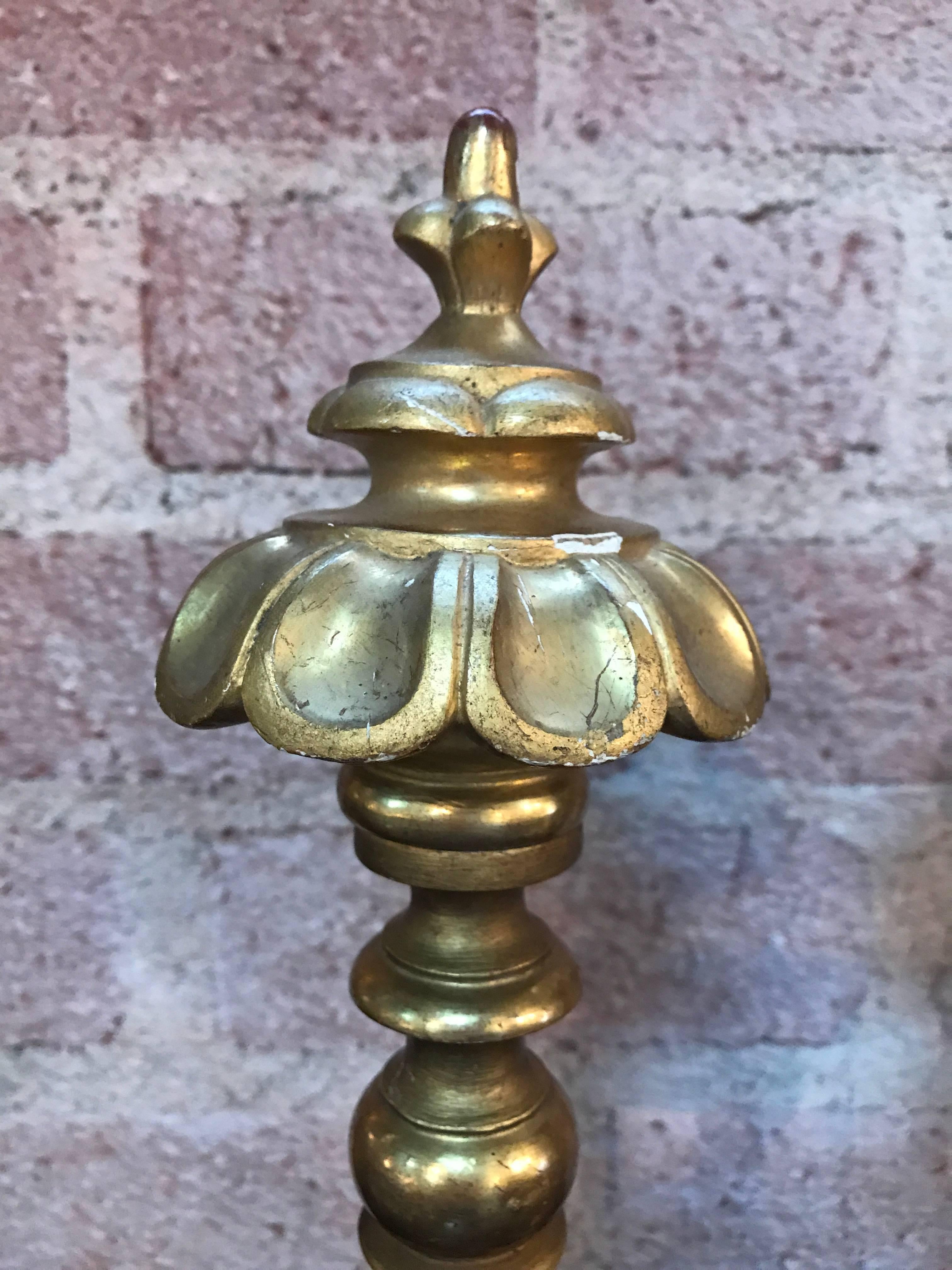 Pair of Italian 22-carat gold leaf carved wood finials that were originally used at the end of drapery rods. They have been mounted on Lucite bases a decoration for a table or bookshelf.