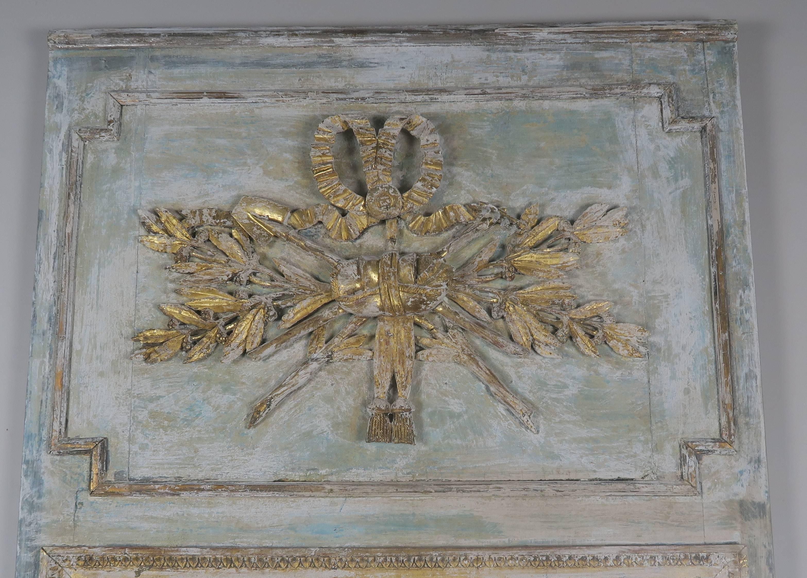 19th century French painted and parcel-gilt mirror depicting crossed laurel leaves, ribbon, bow and tassels.