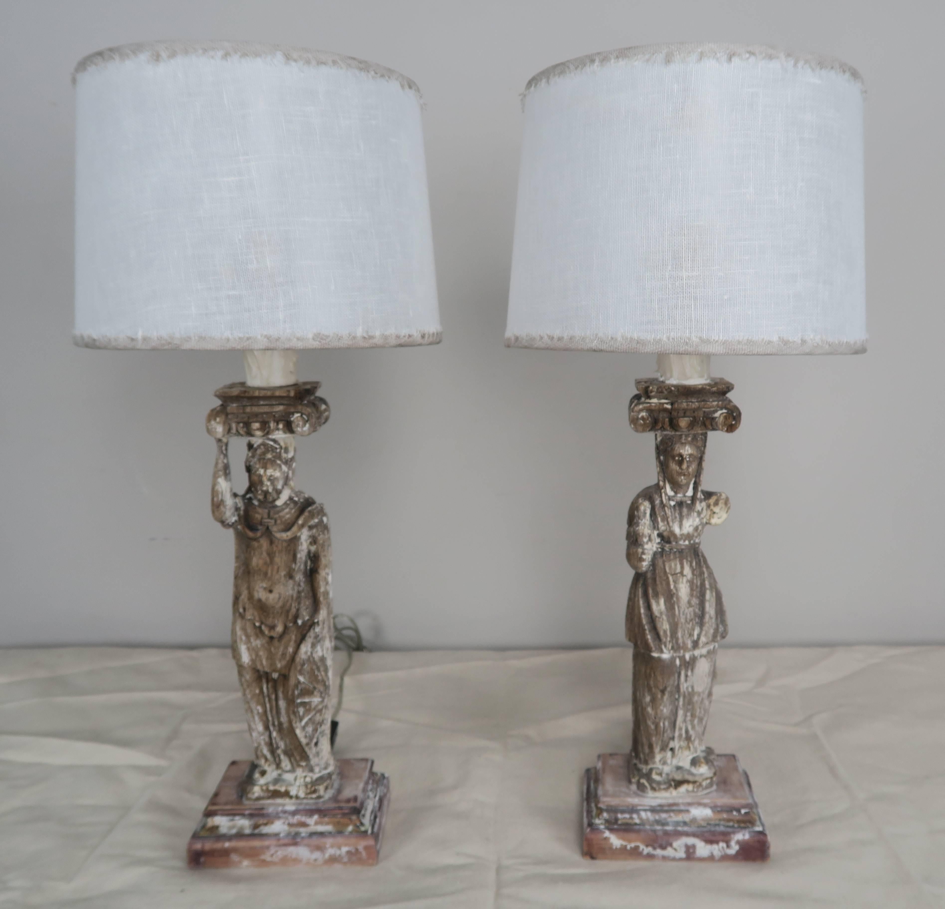 19th century neoclassical figures wired into lamps and crowned with custom linen shades. Newly wired with drip wax candle covers.