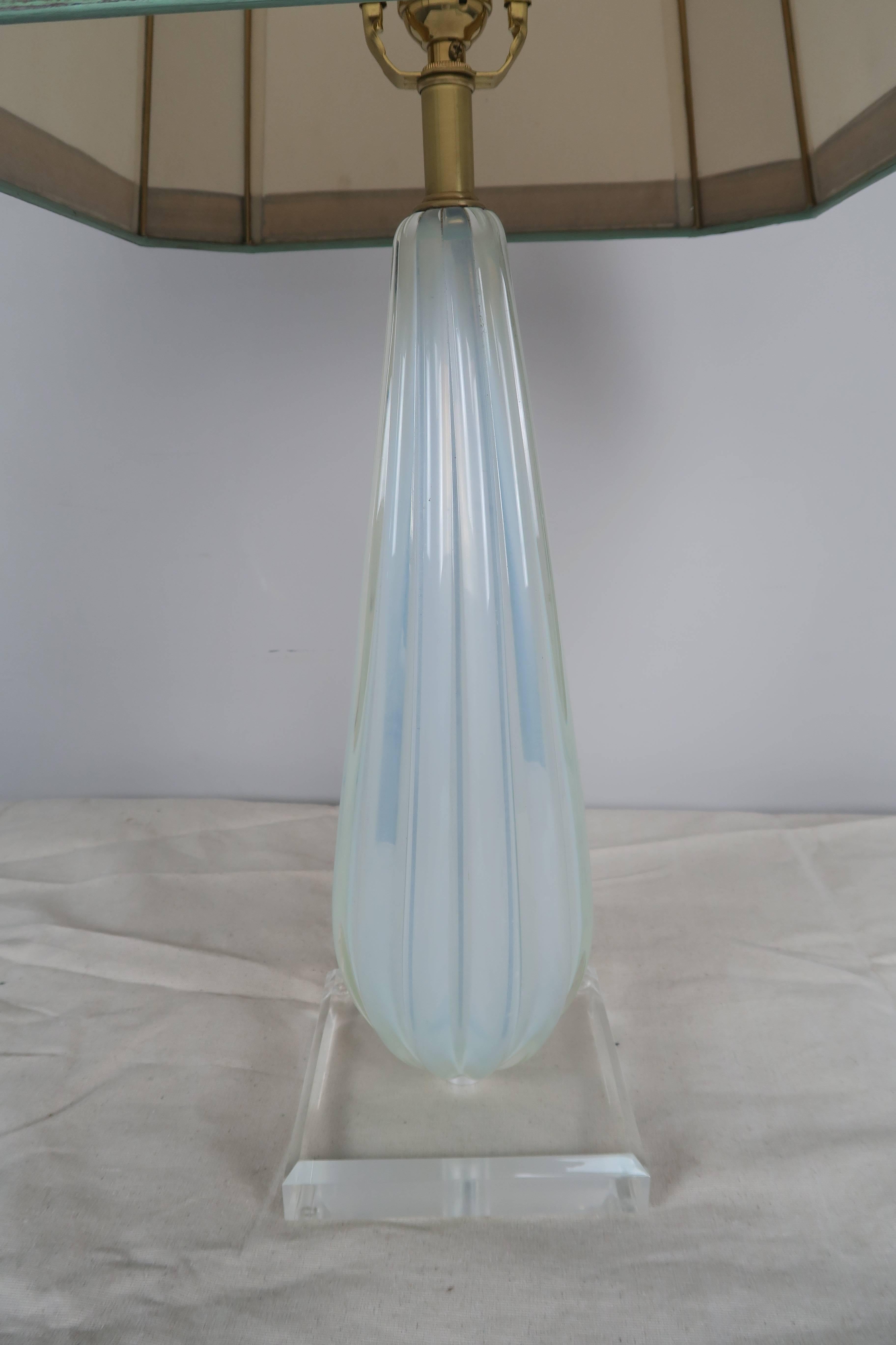 Italian Murano handblown glass lamp in a soft aqua blue coloration. The lamp sits on a square Lucite base and is crowned with a hand-painted parchment shade with gold leaf detailing.
