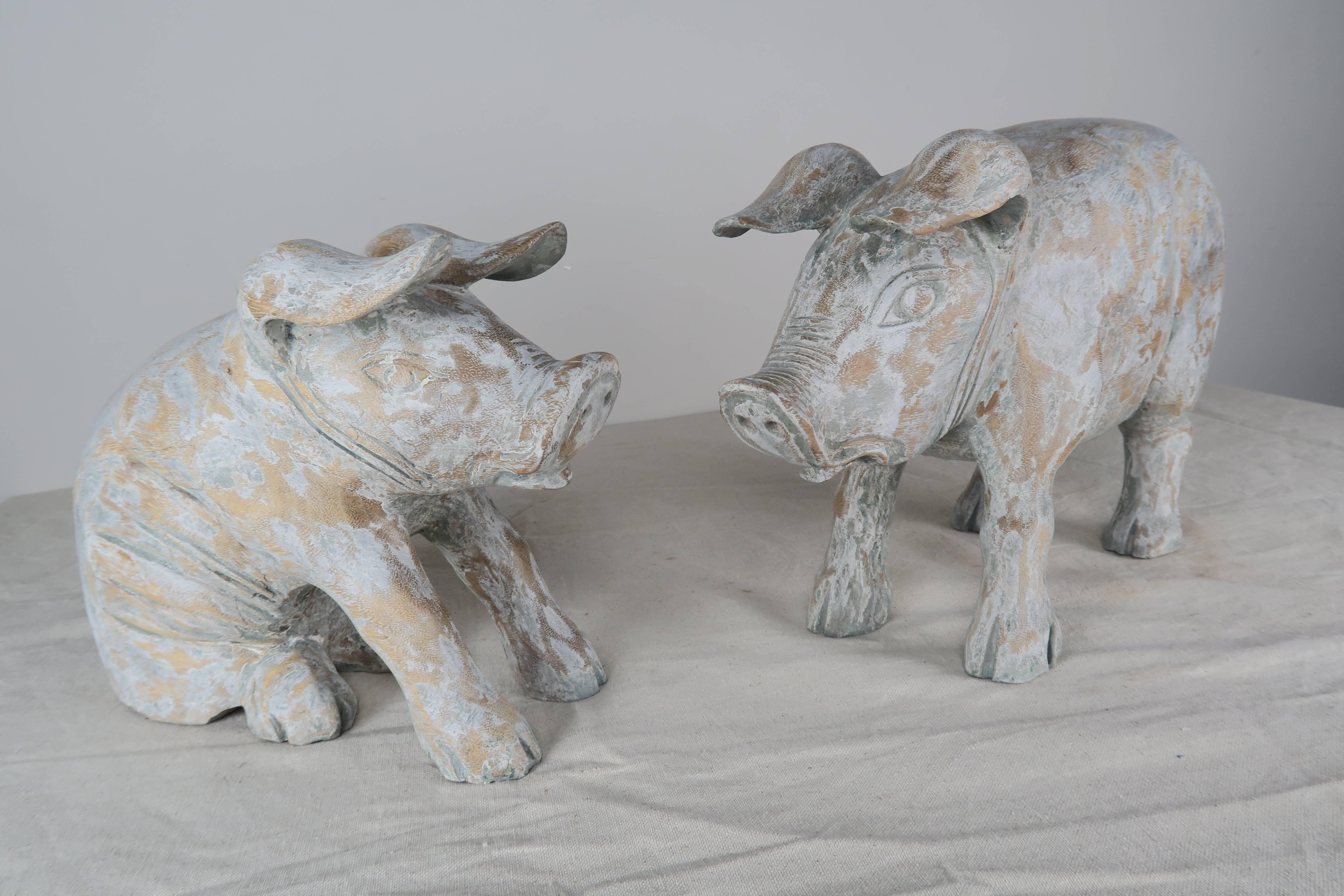 Pair of charming carved wood painted pigs.

Smaller seated pig is 12