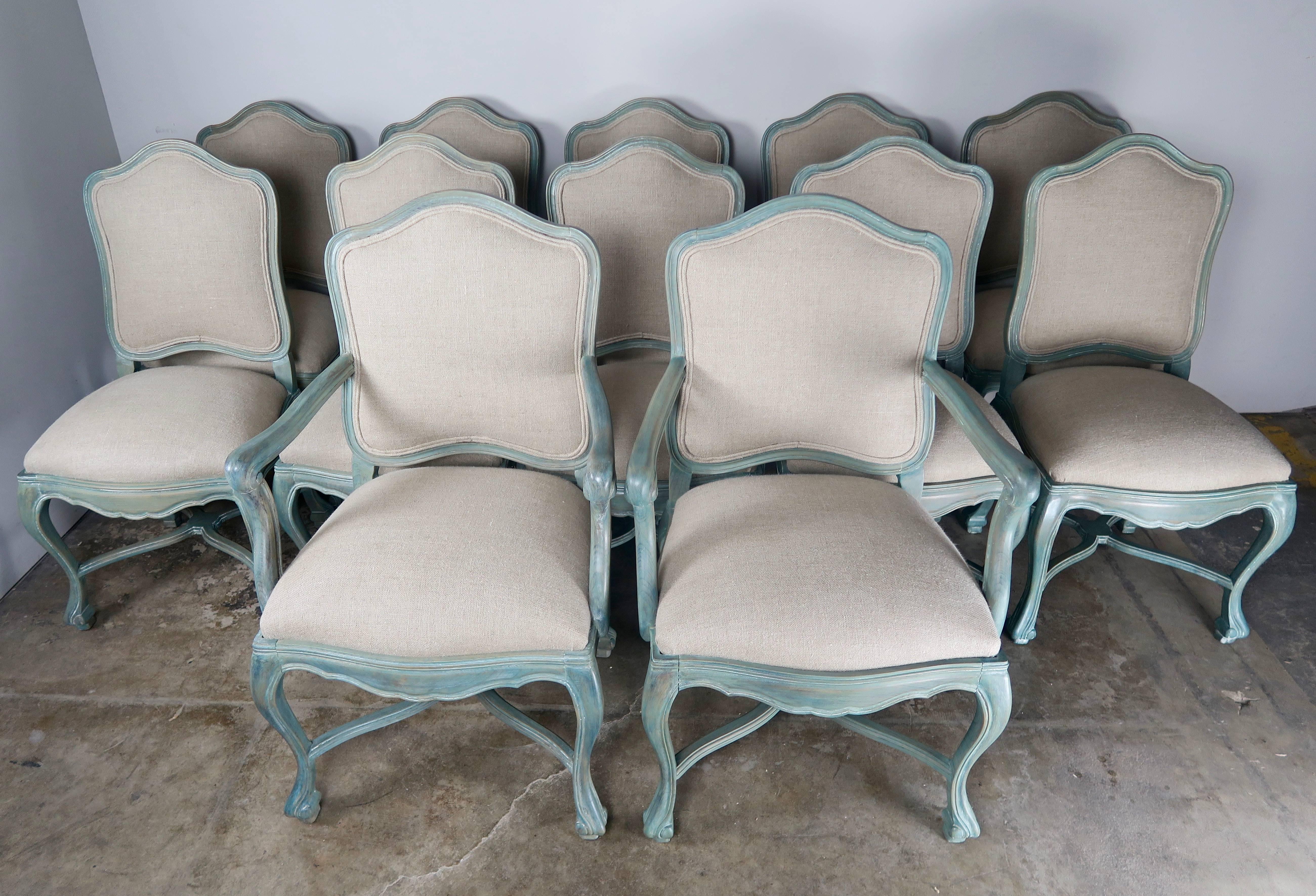 Set of 8 French Louis XV style aqua colored painted dining chairs newly upholstered in Belgium linen with double cord detail. The chairs Stand on four cabriole legs that are connected by a bottom stretcher.
Size armchair: 25