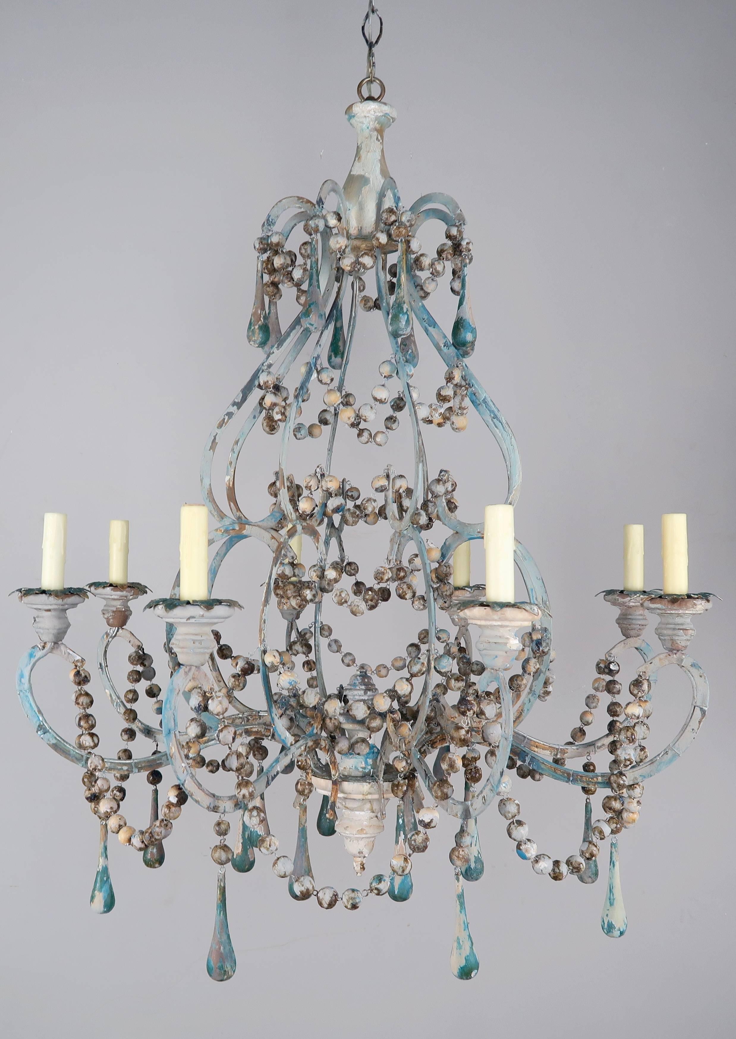 Pair of eight light wood beaded and metal chandeliers with blue tear drops and wooden bobeches with drip wax candle covers. The fixtures have been newly wired with chain and canopy and are ready to install.