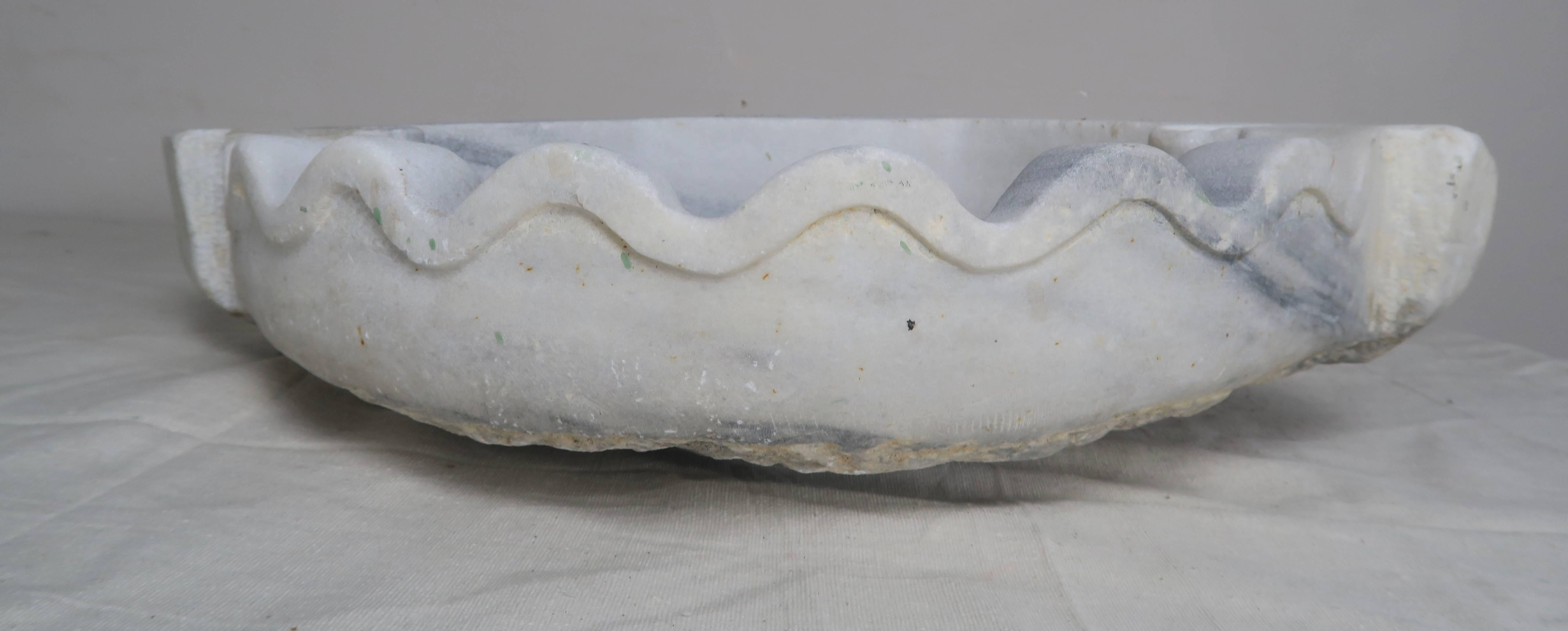 Diamond shape marble corner sink with scalloped edge and indentations for your glass.