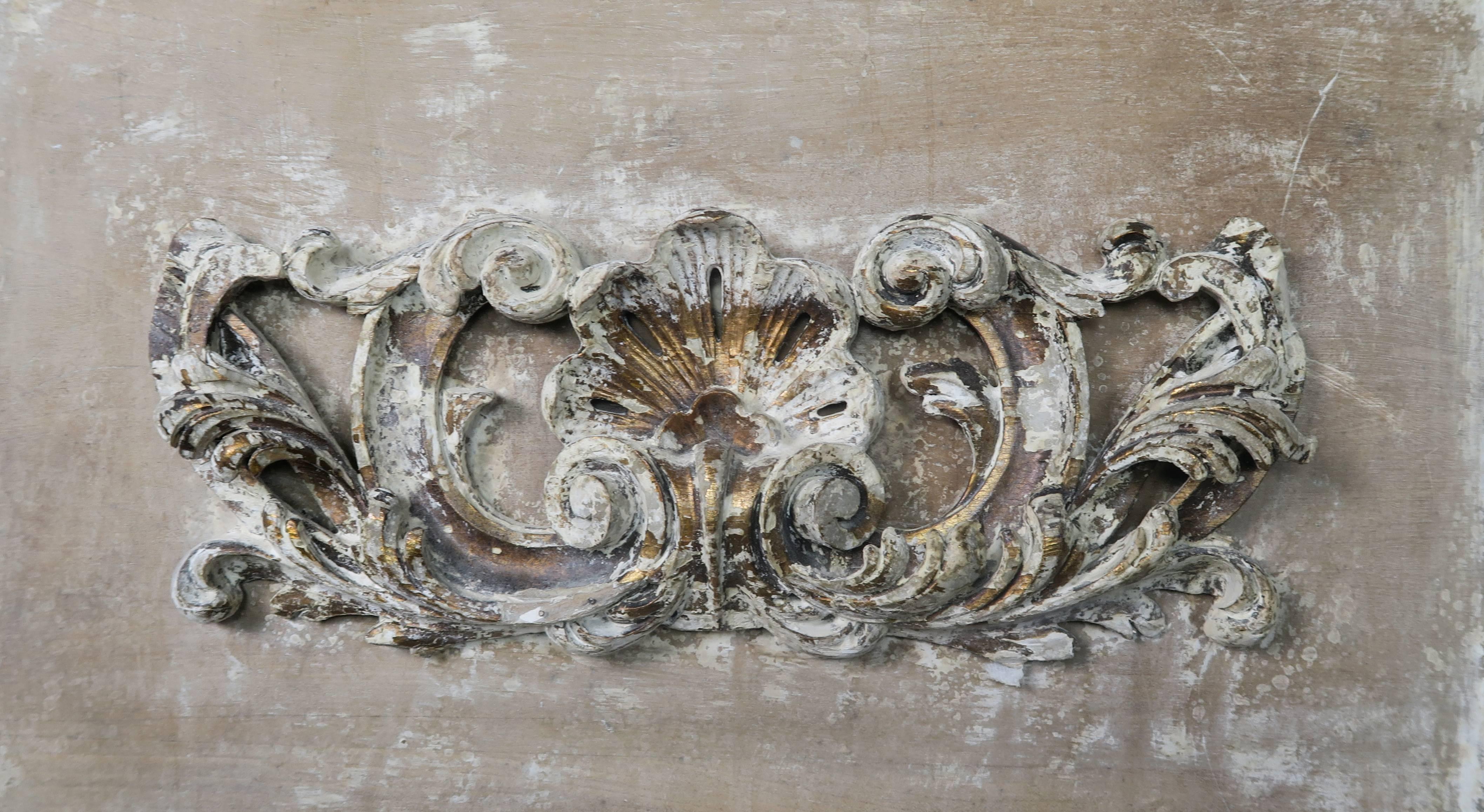 19th century painted Swedish carved wood mirror with centre shell carving flanked by swirling acanthus leaves. Distressed antique white finish with wood exposed in areas and remnants of painted and gold leaf throughout.