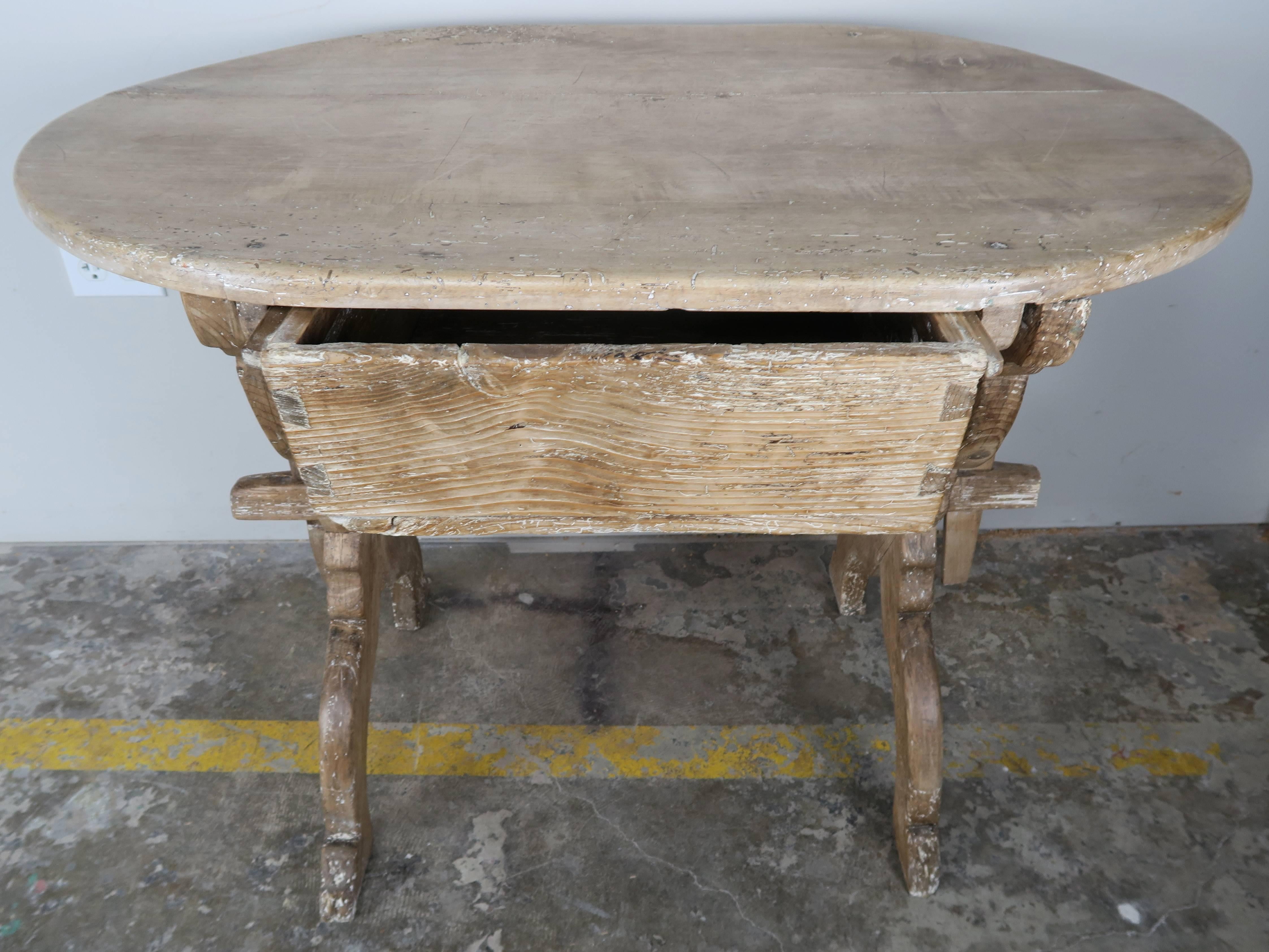 French 19th century primitive pine and elmwood table with large centre drawer and bottom stretcher.