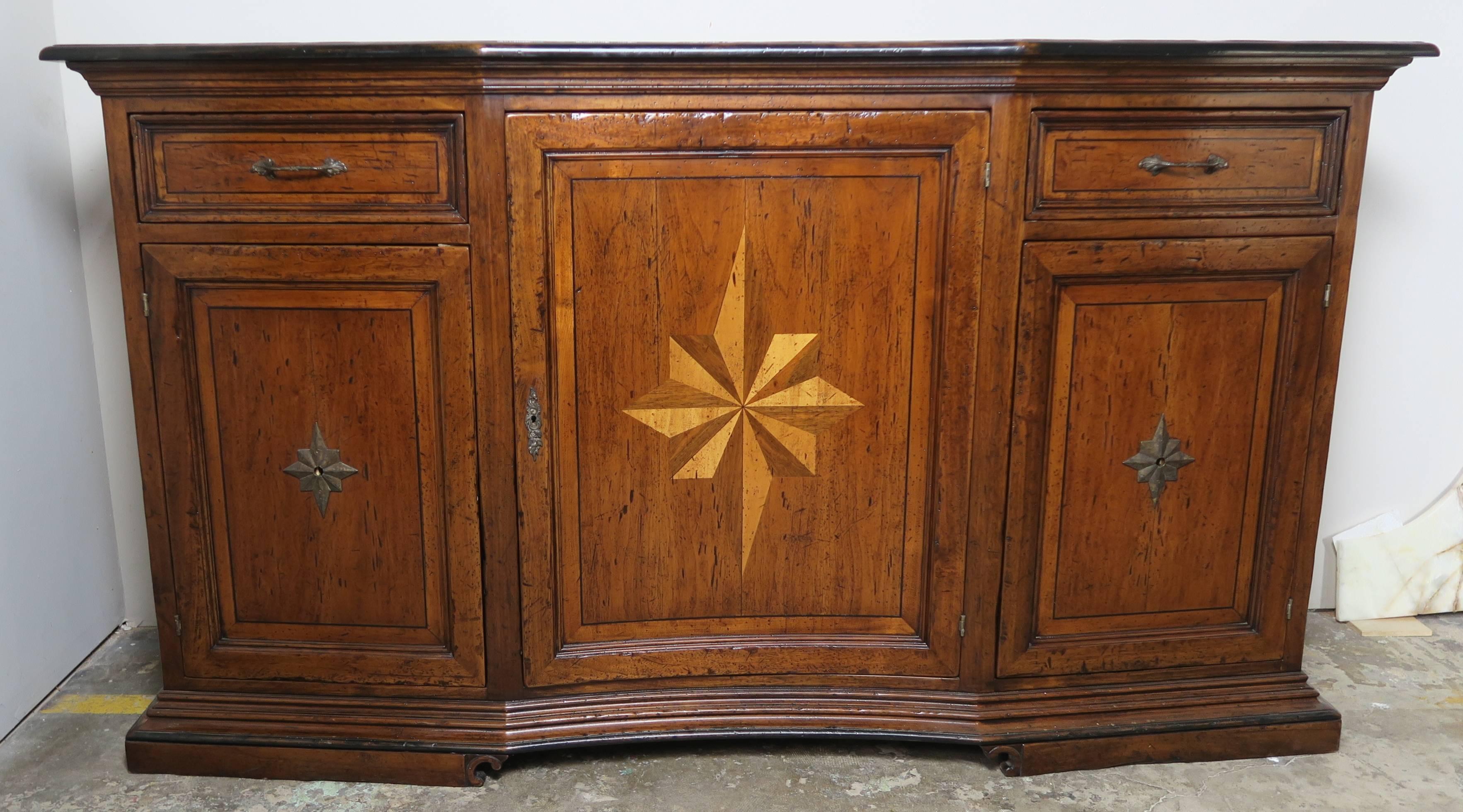 Italian walnut credenza with inlaid maple and mahogany stars on the front door and both sides of the piece. Three doors and two drawers with shelves and plenty of storage. The wood on this piece is rich in color and has developed a beautiful patina