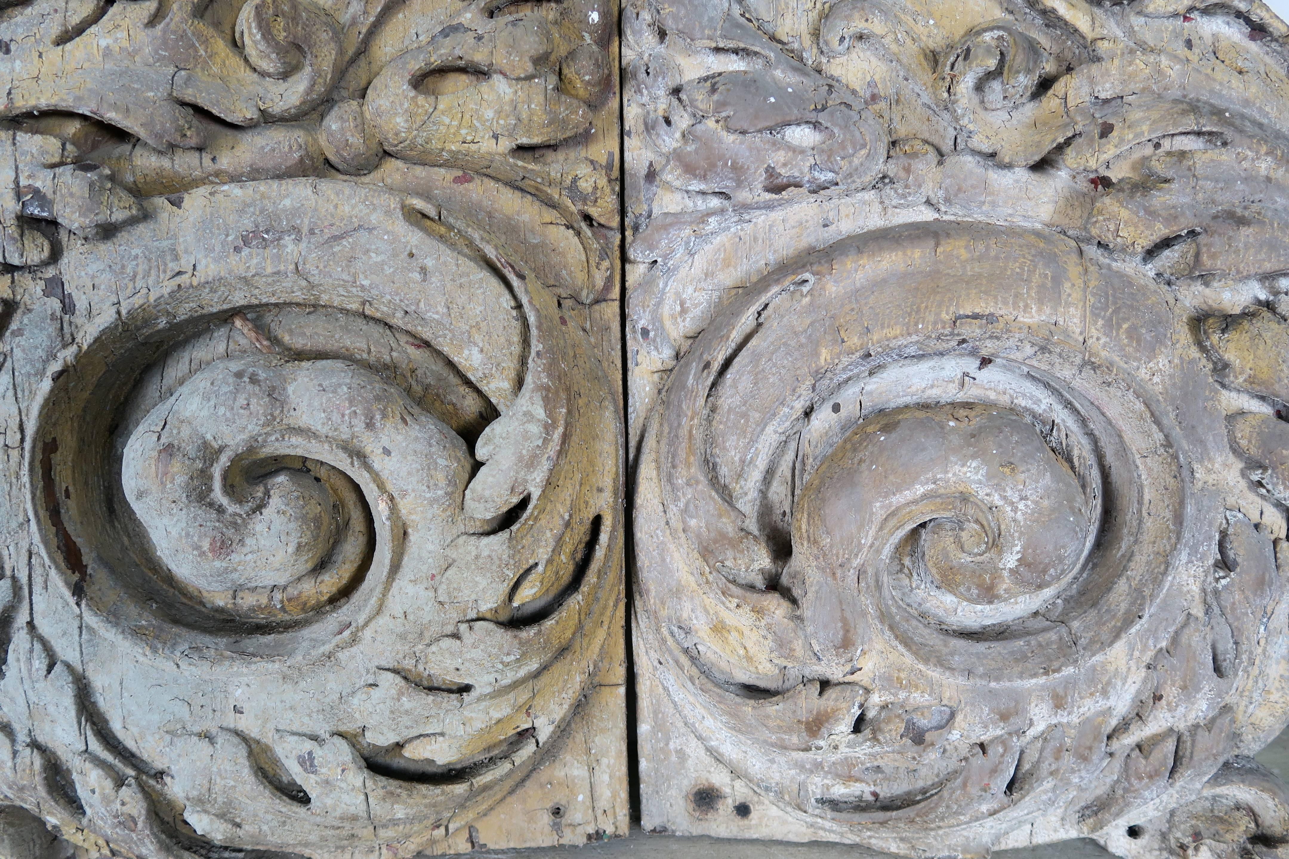 Pair of carved monumental size scrolled acanthus leaf decor from the early 1900s. They were part found in a theater in Italy and made of some sort of composition. Great original finish-weathered beautifully.