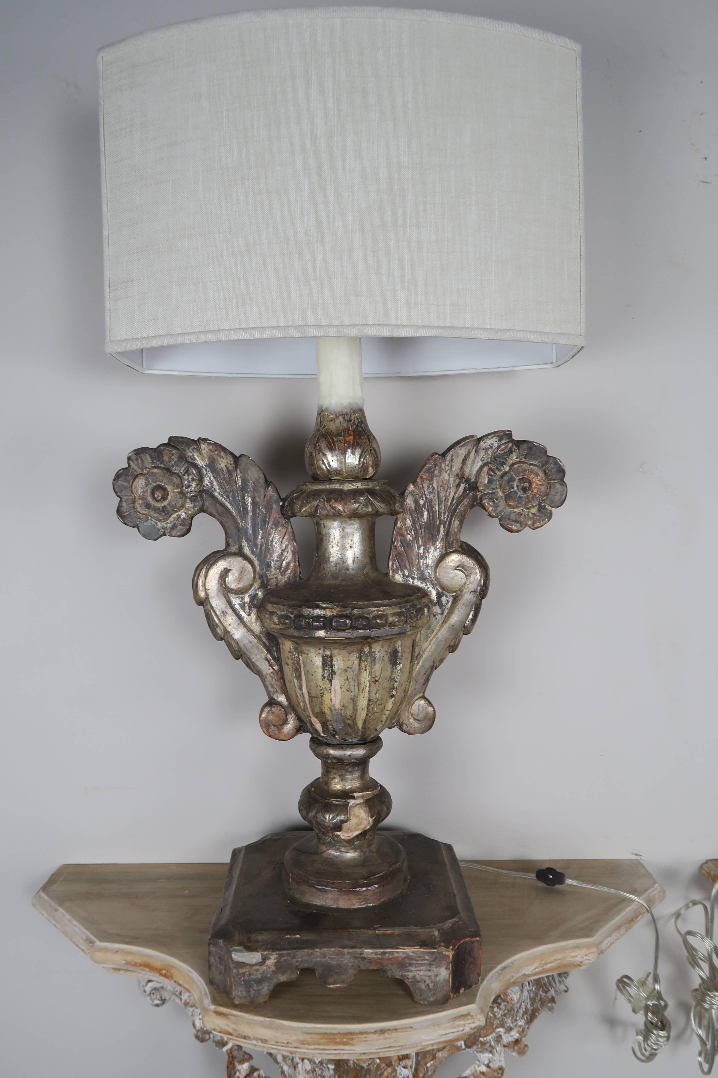 Pair of 19th century Italian carved wood silvered large scale urns wired into lamps with white linen shades.