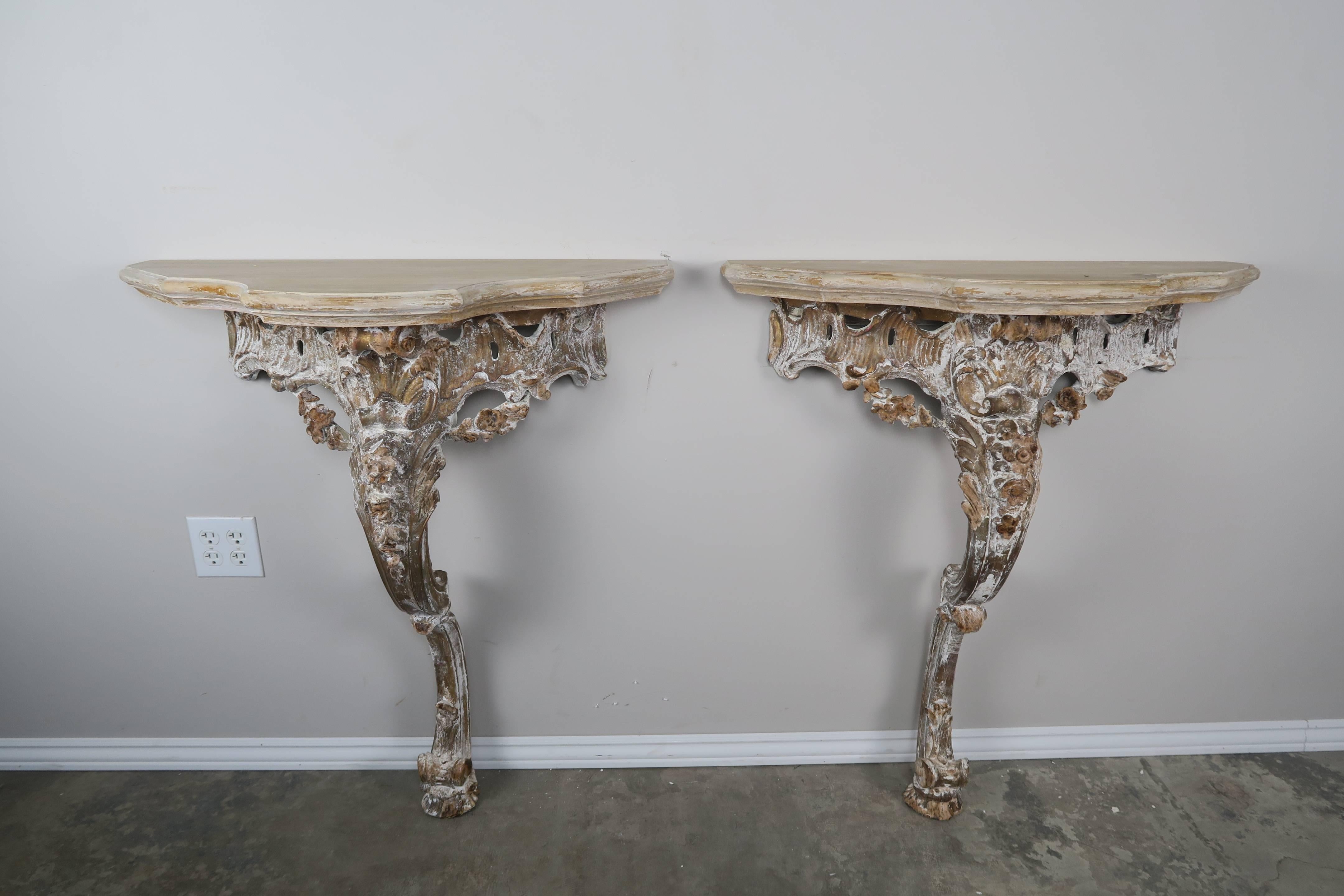 Pair of French Rococo style painted consoles with scalloped tops.