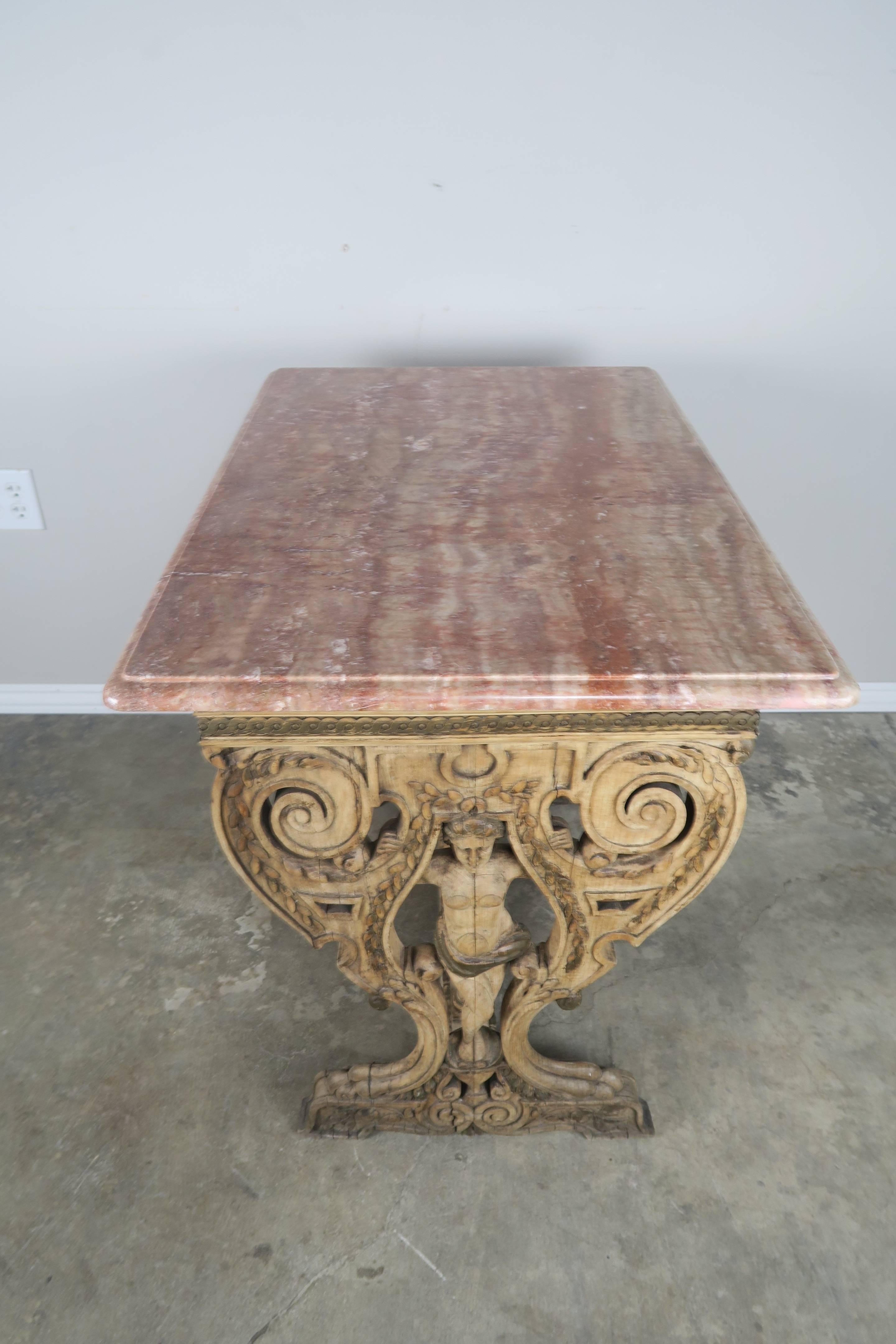 19th century Italian bleached walnut carved figural table with original terra cotta and golden marble top.
