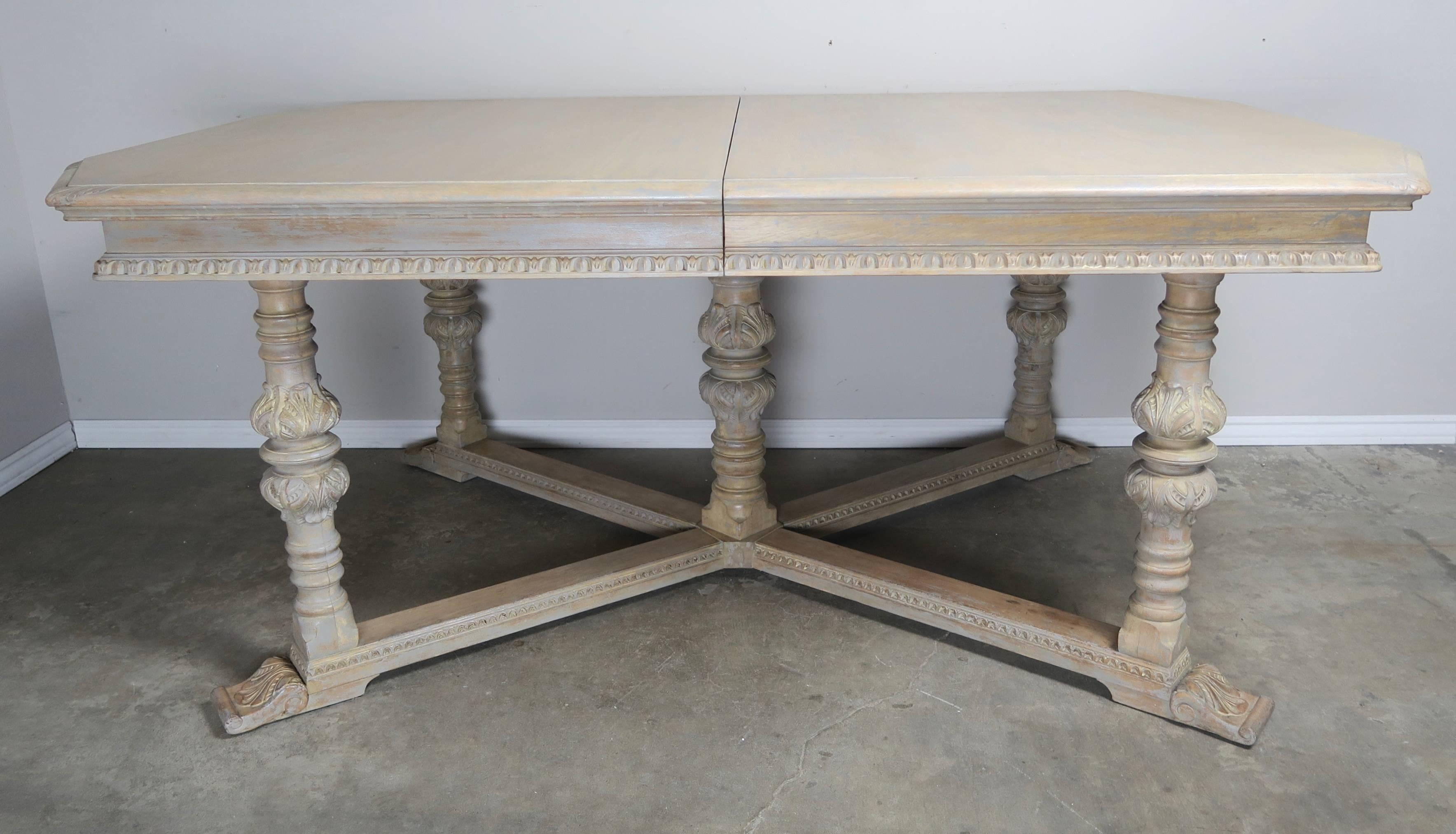 Italian lightly painted neoclassical style dining room table with three leaves. The table stands on five straight legs and are connected by a bottom 