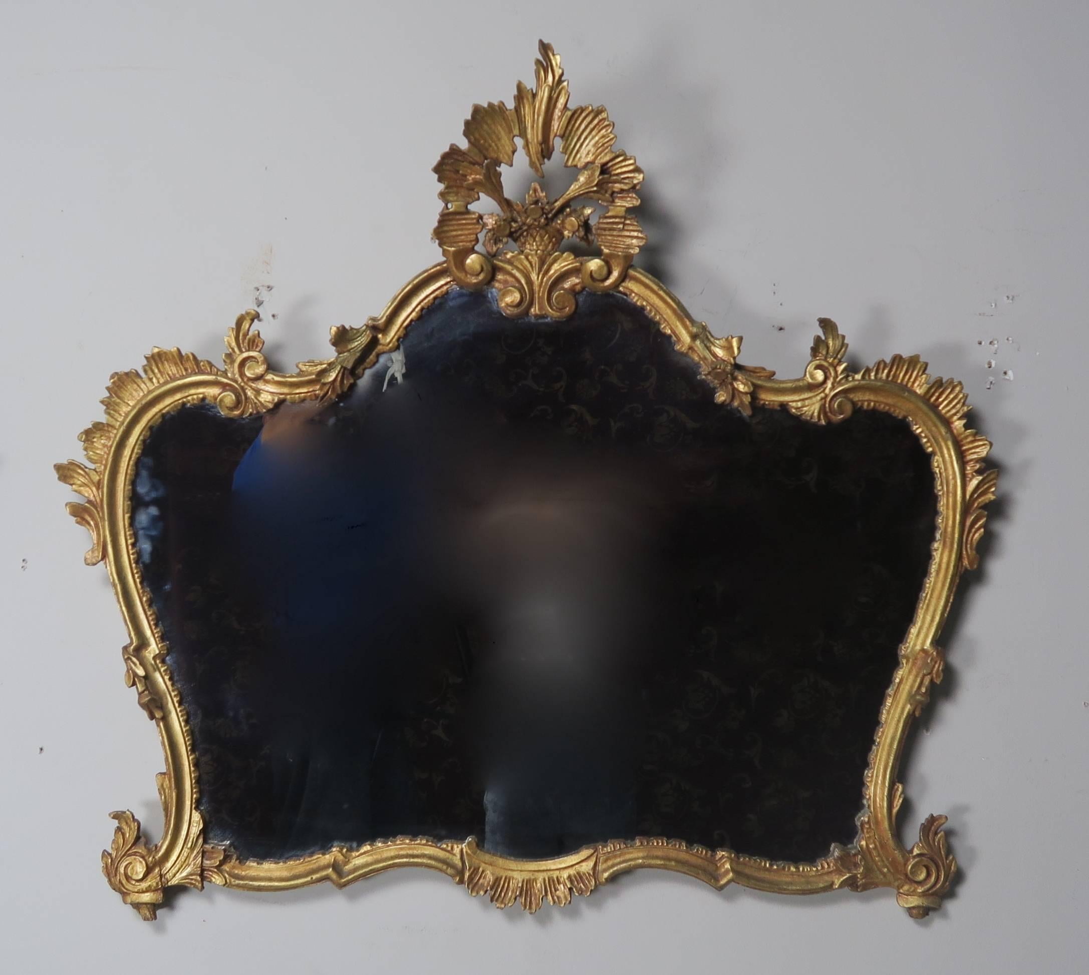 Pair of French giltwood mirrors with hand-carved details, circa 1930s.