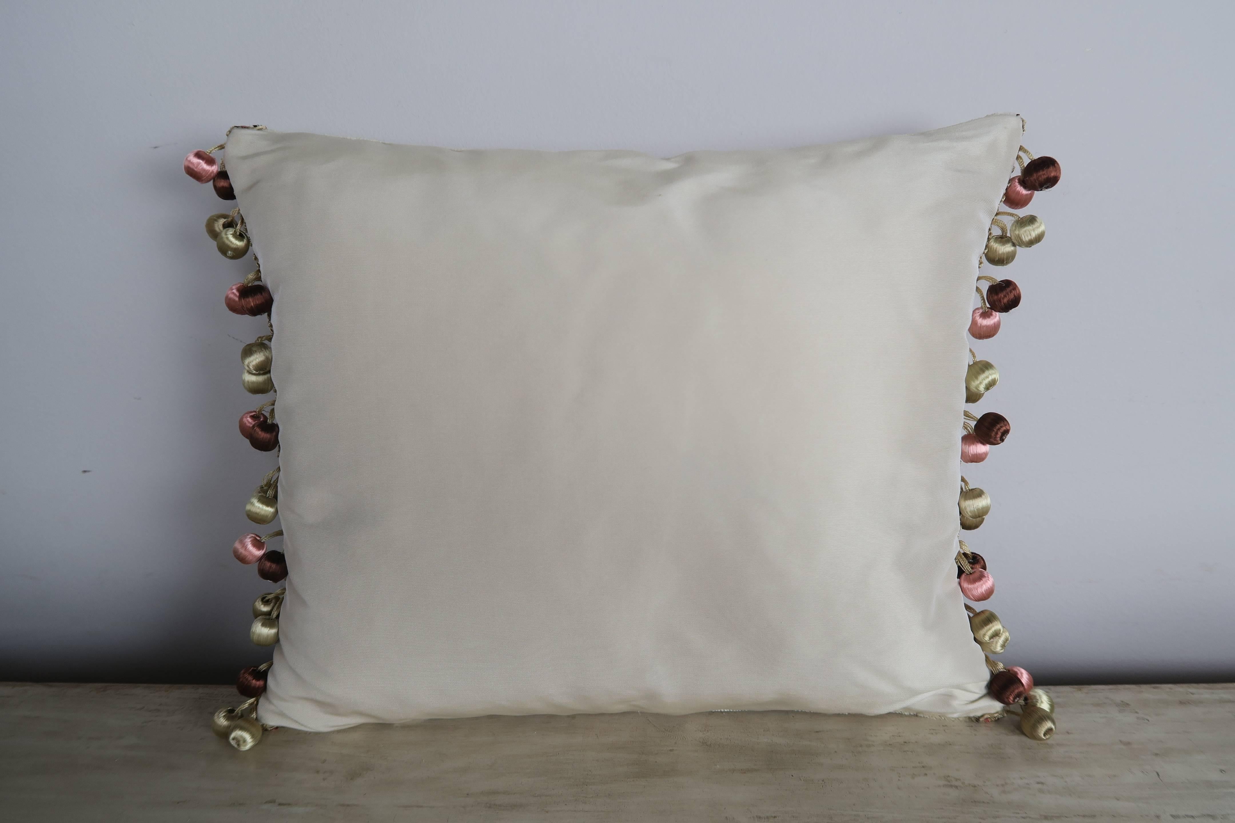 Pair of custom pillows made with 19th century French metallic and chenille embroideries applied to contemporary linen velvet and finished with a multi colored ball fringe detail. Down inserts, zipper closures.

 