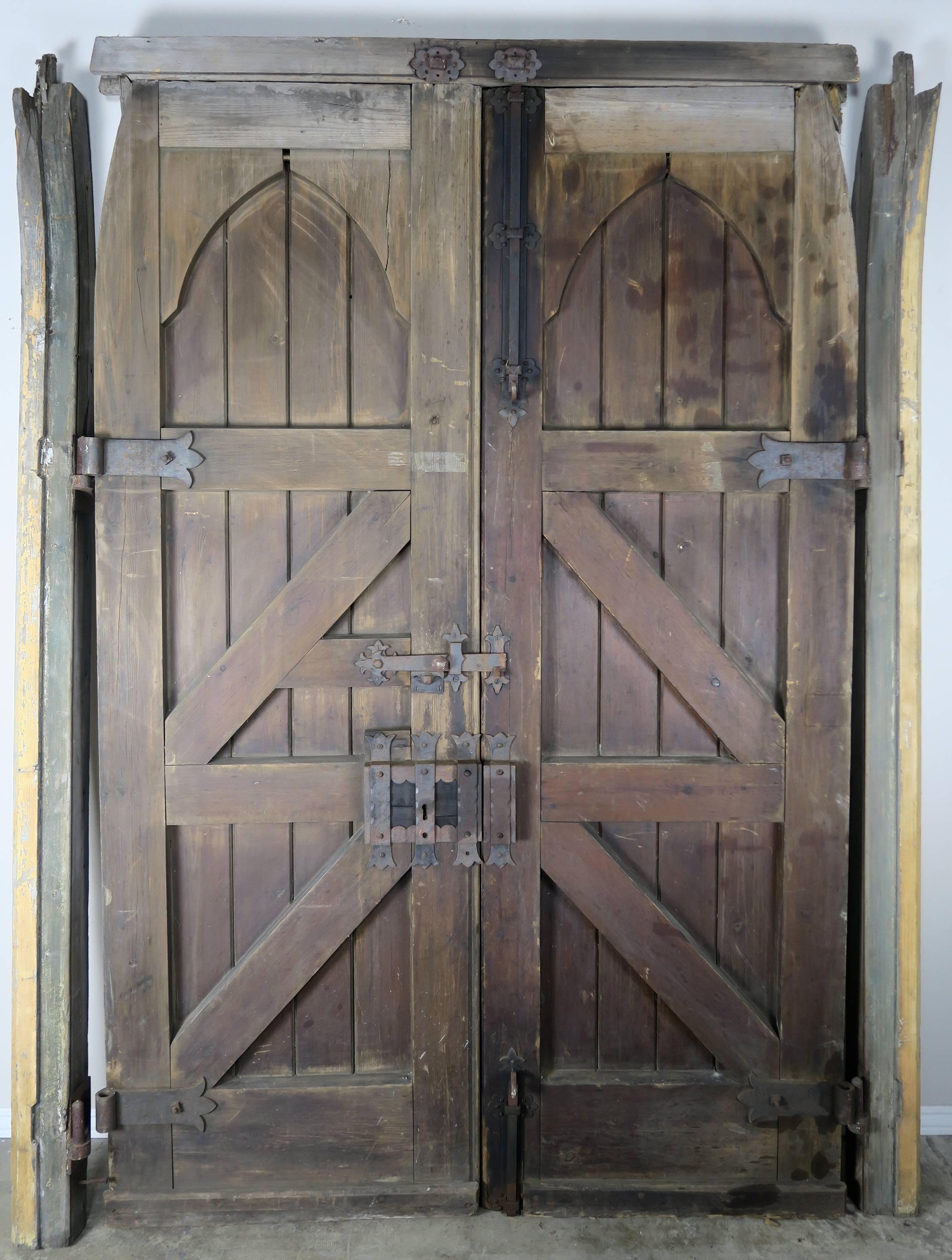Pair of monumental Spanish barn doors with heavy iron hinges on door fronts and detailed locking iron hardware on inside.

Each Door is 29