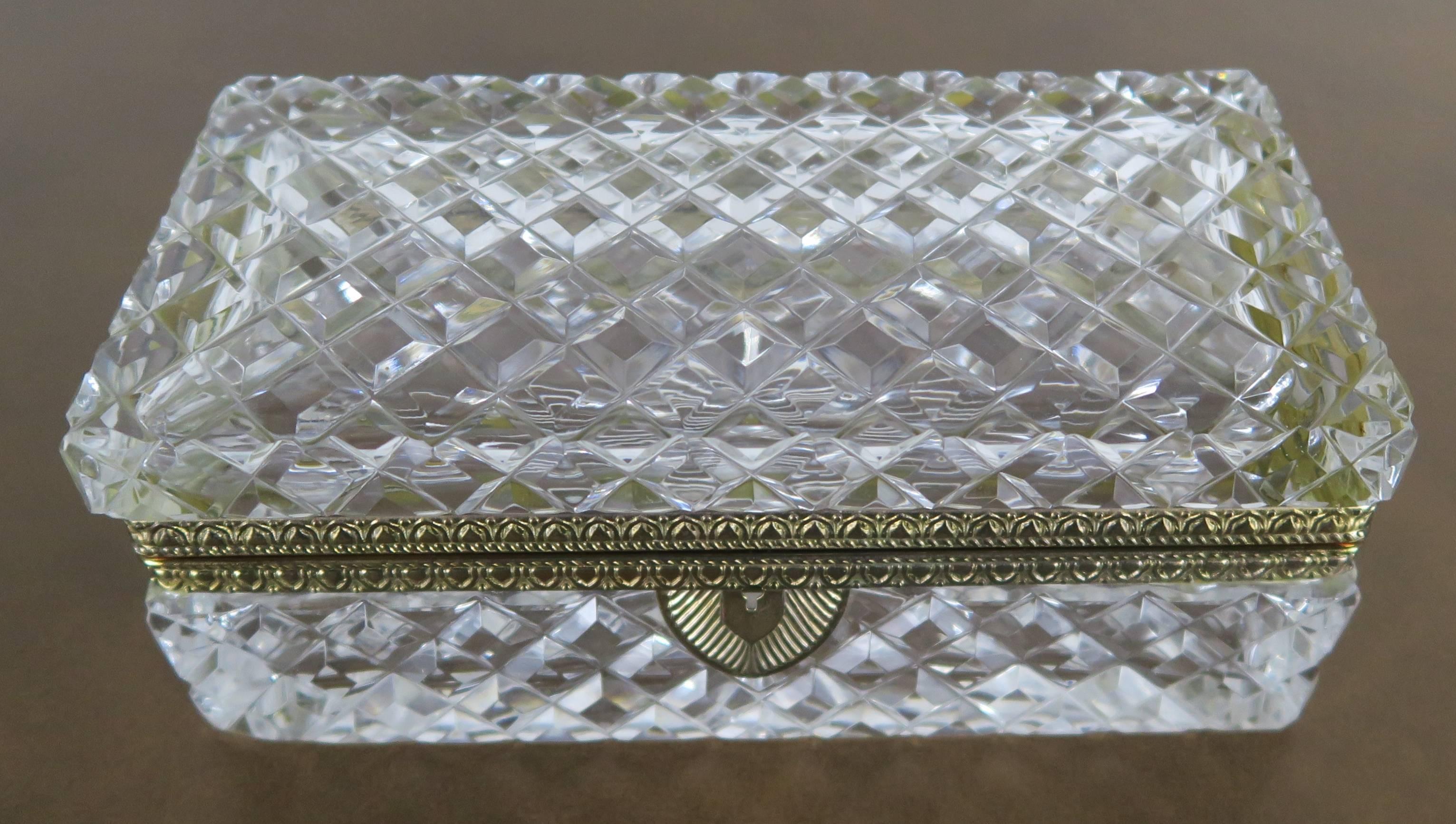 French cut crystal and brass rectangular shaped jewelry casket with keyhole. Beautiful starburst pattern on the bottom of the box.