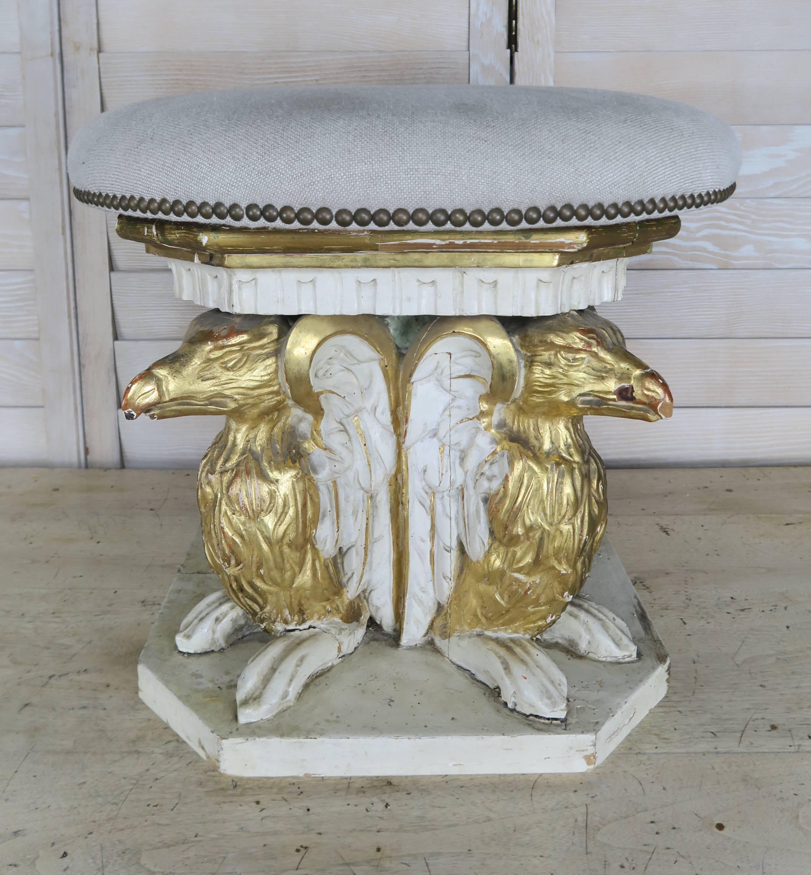 Pair of 19th century Italian painted and parcel-gilt stools comprised of four winged griffins. The stools are newly upholstered in Belgium linen and detailed with nail head trim.