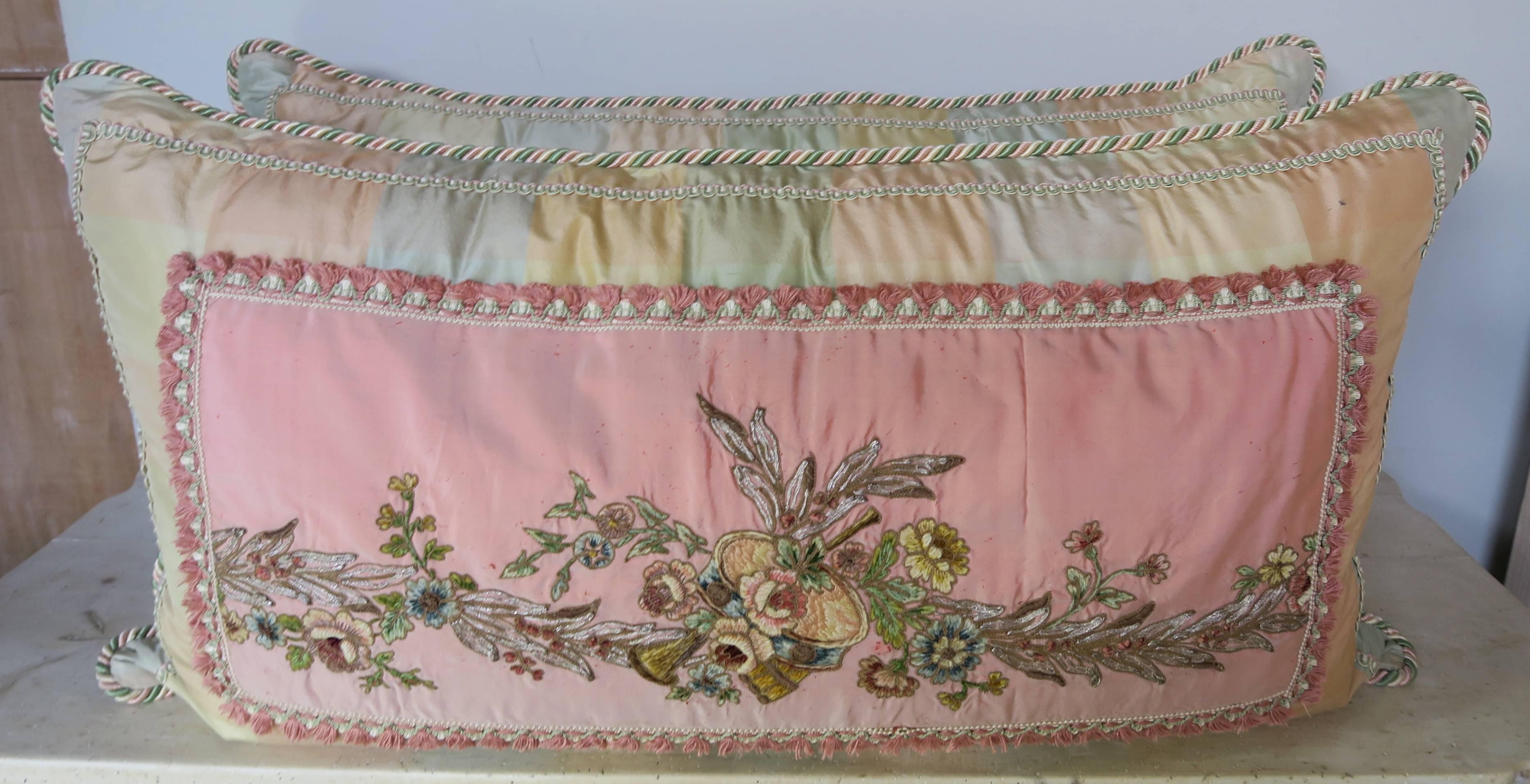 A pair of custom pillows made with 19th century French metallic and chenille embroidered applique combined with contemporary silk and trims to create a pair of magnificent bed or sofa pillows. These pillows are works of art. Down inserts, sewn
