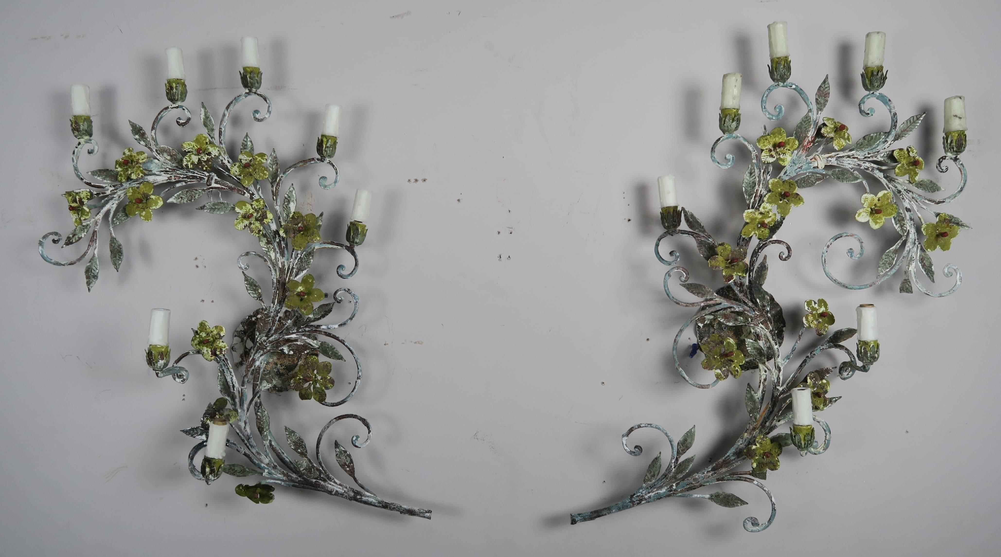 A pair of French wrought iron painted seven-light garland sconces. The garden themed sconces have a beautiful distressed painted finish. They have been newly rewired with drip wax candle covers.