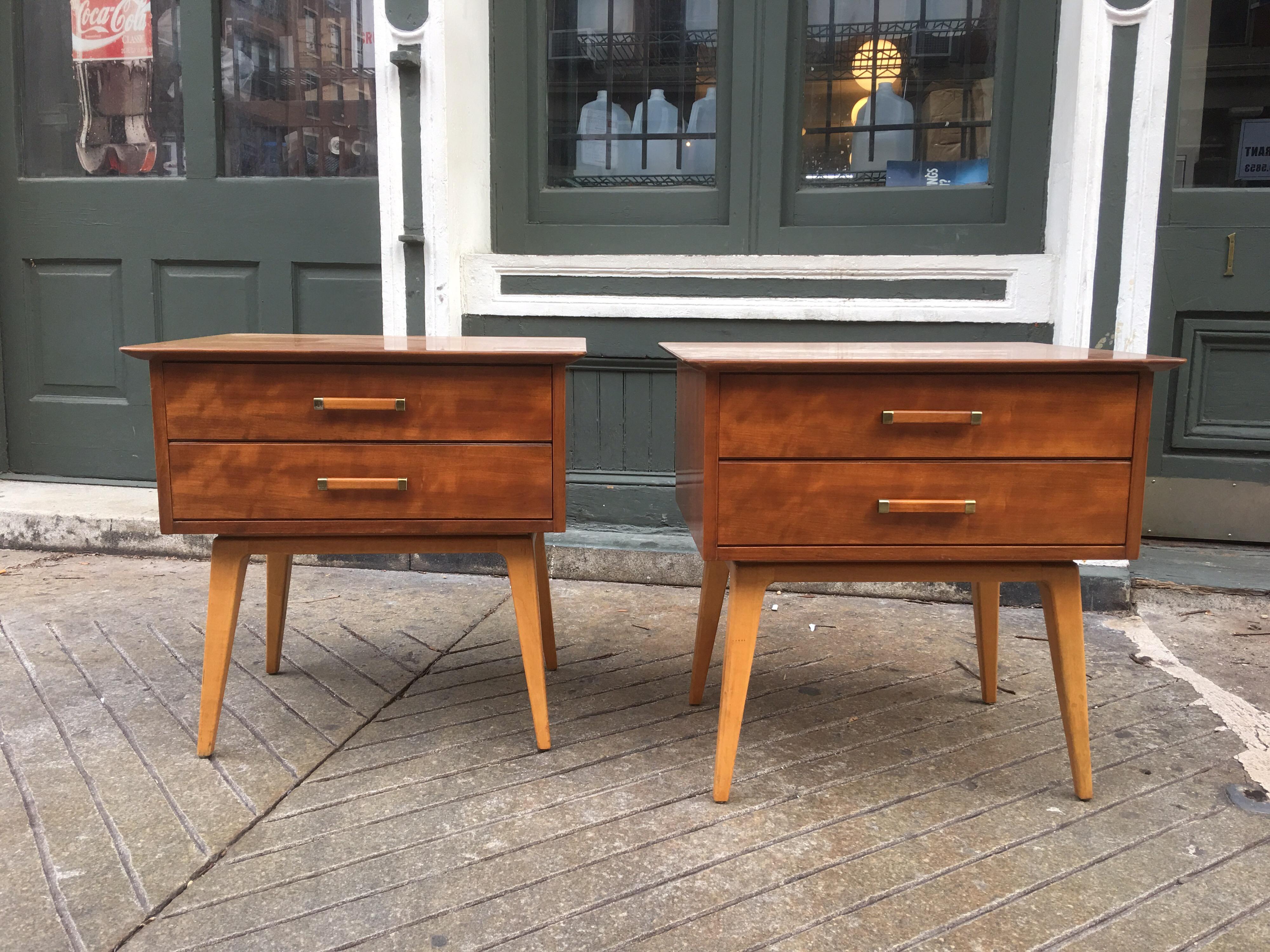 Renzo Rutili pair of nightstands for Johnson Furniture Company. Walnut tops with tapered birch legs. Beveled edge tops overhang cabinet bodies. Nightstands are finished on all sides.