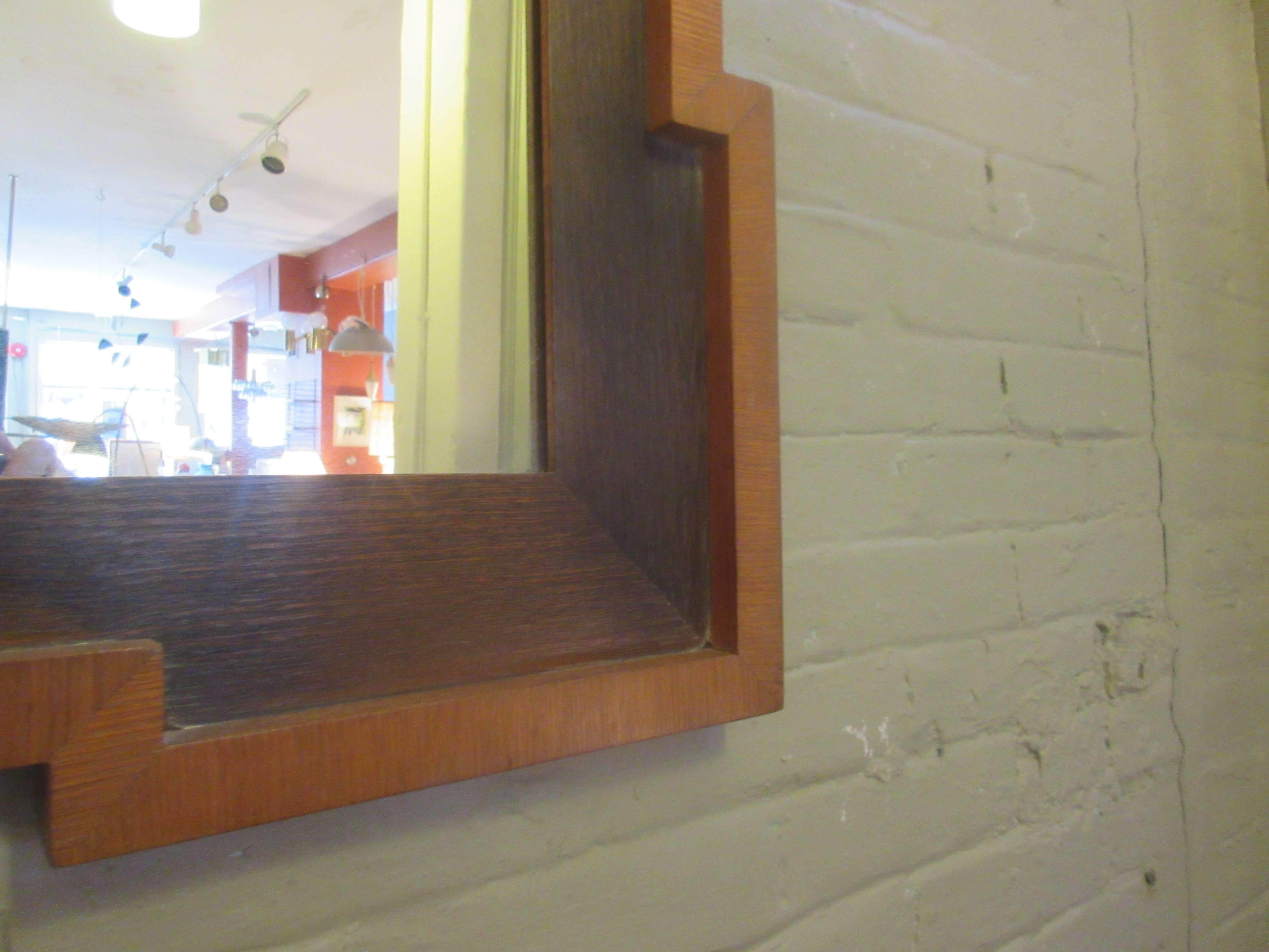 Veneered framed wall mirror from the 1940s with ebonized interior frame and honey oak outer frame.