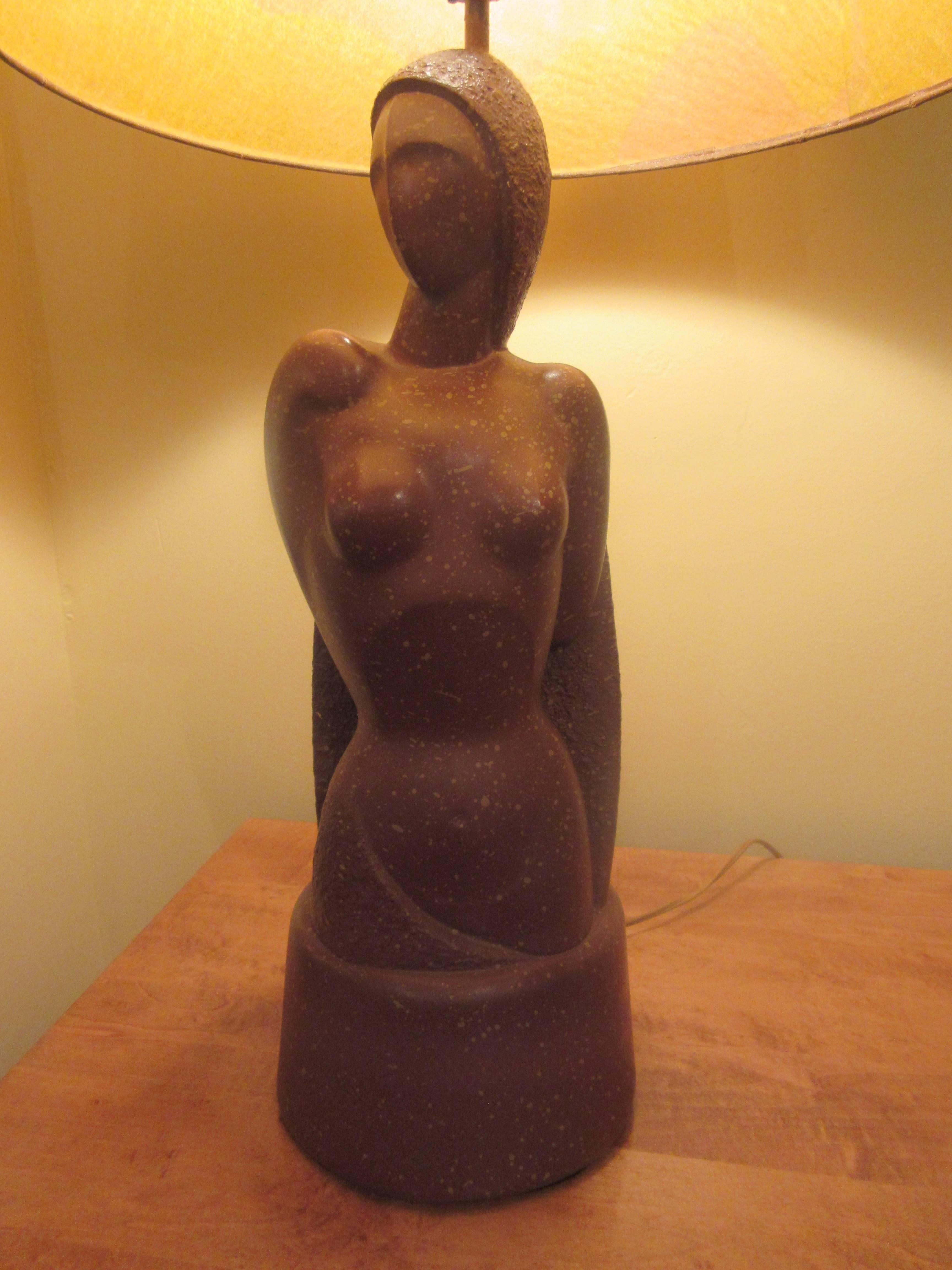 Extraordinary plaster lamp of a female nude painted with a speckled motif and paired with an unusual paper printed shade. Bought from the original owner and in perfect condition.