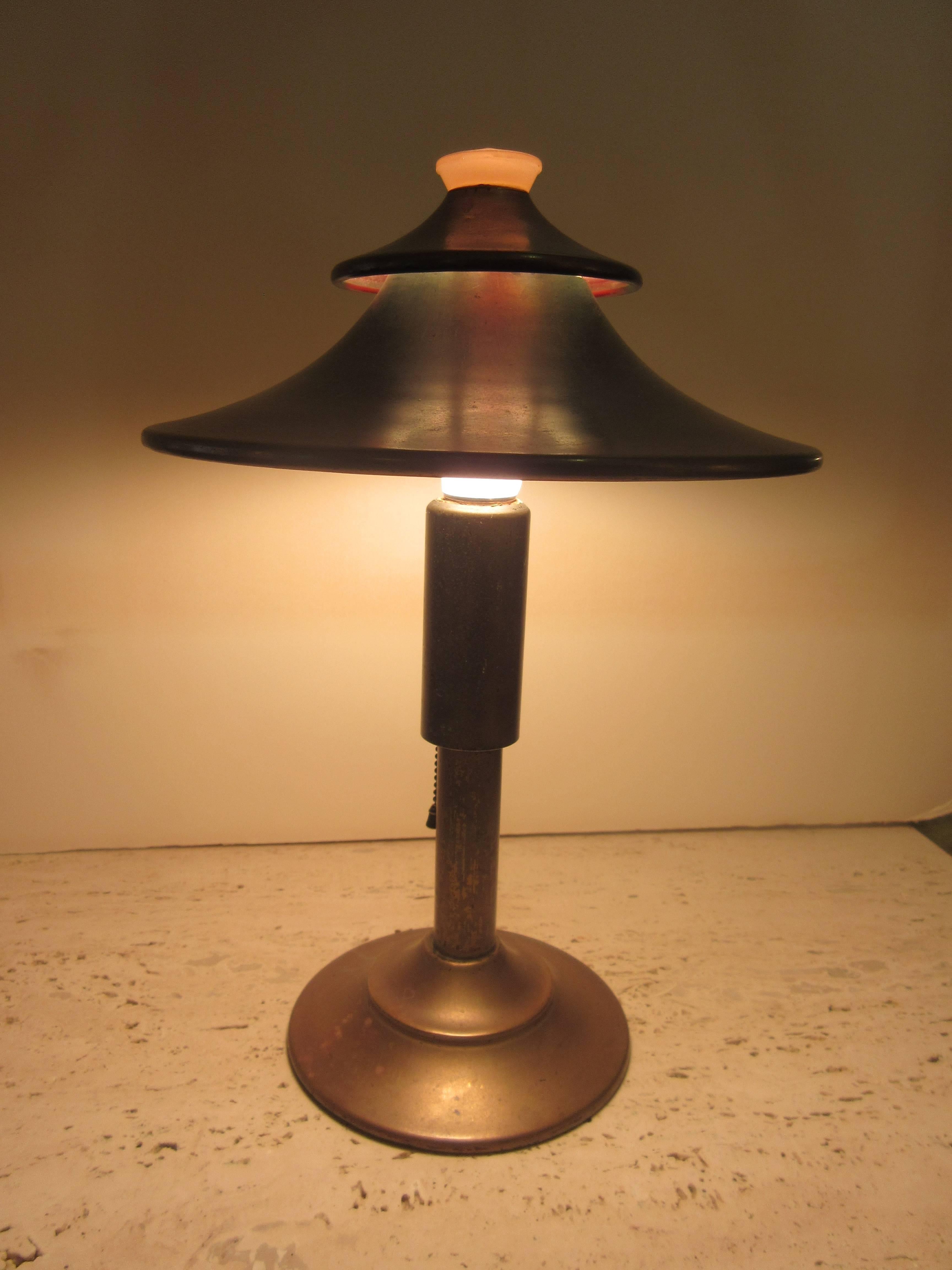 This Pagoda lamp actually designed by Leroy Doane had for years been misattributed to KEM Weber. Manufactured by the Miller Company in the early 1930s. This is a very original, desirable version with the pull chain switch. Peach glass diffuser top