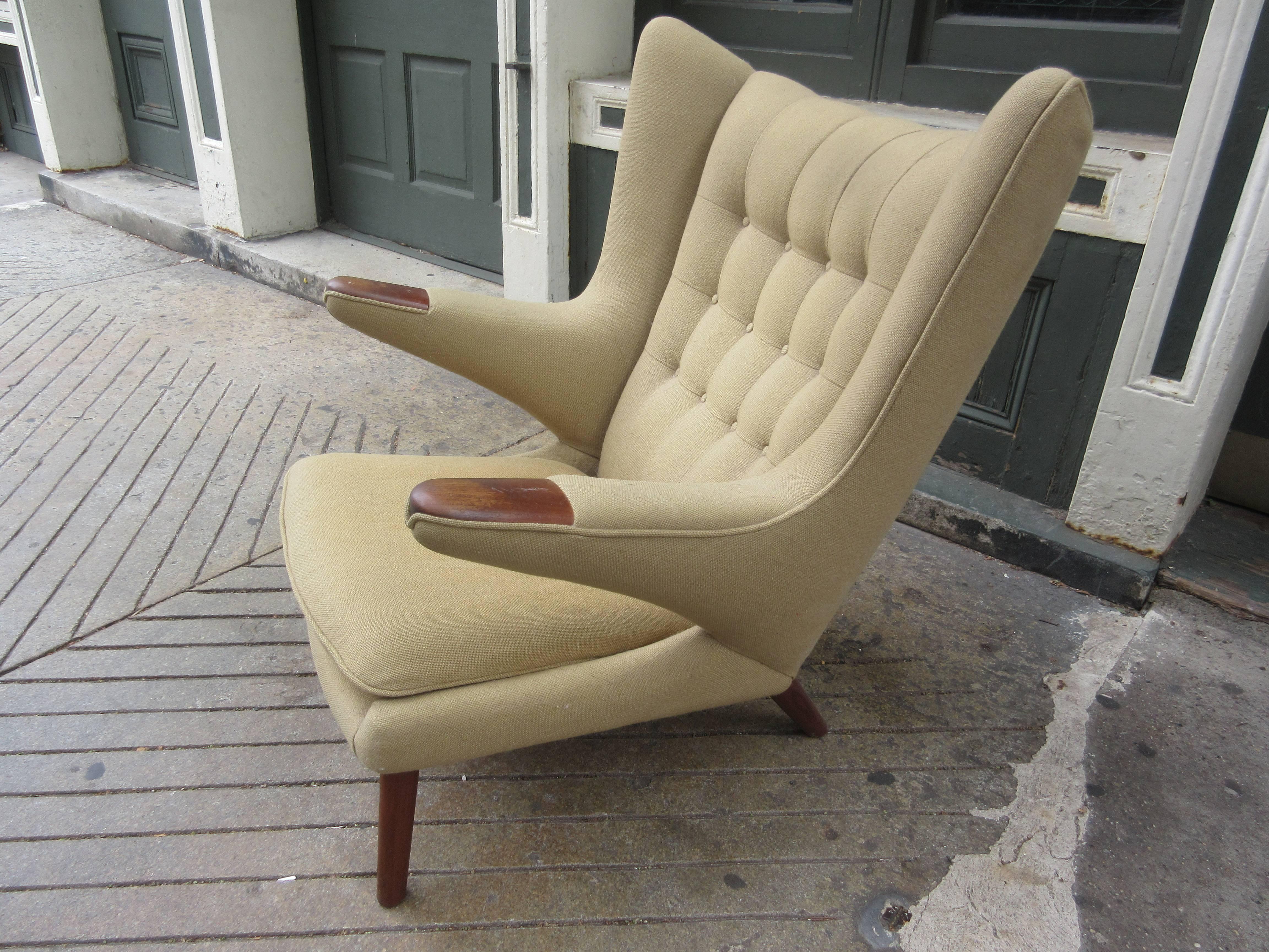 Early chair and ottoman recovered over 20 years ago in a camel Knoll hopsack. Still serviceable but most would choose to recover. Teak is all original and in great condition.