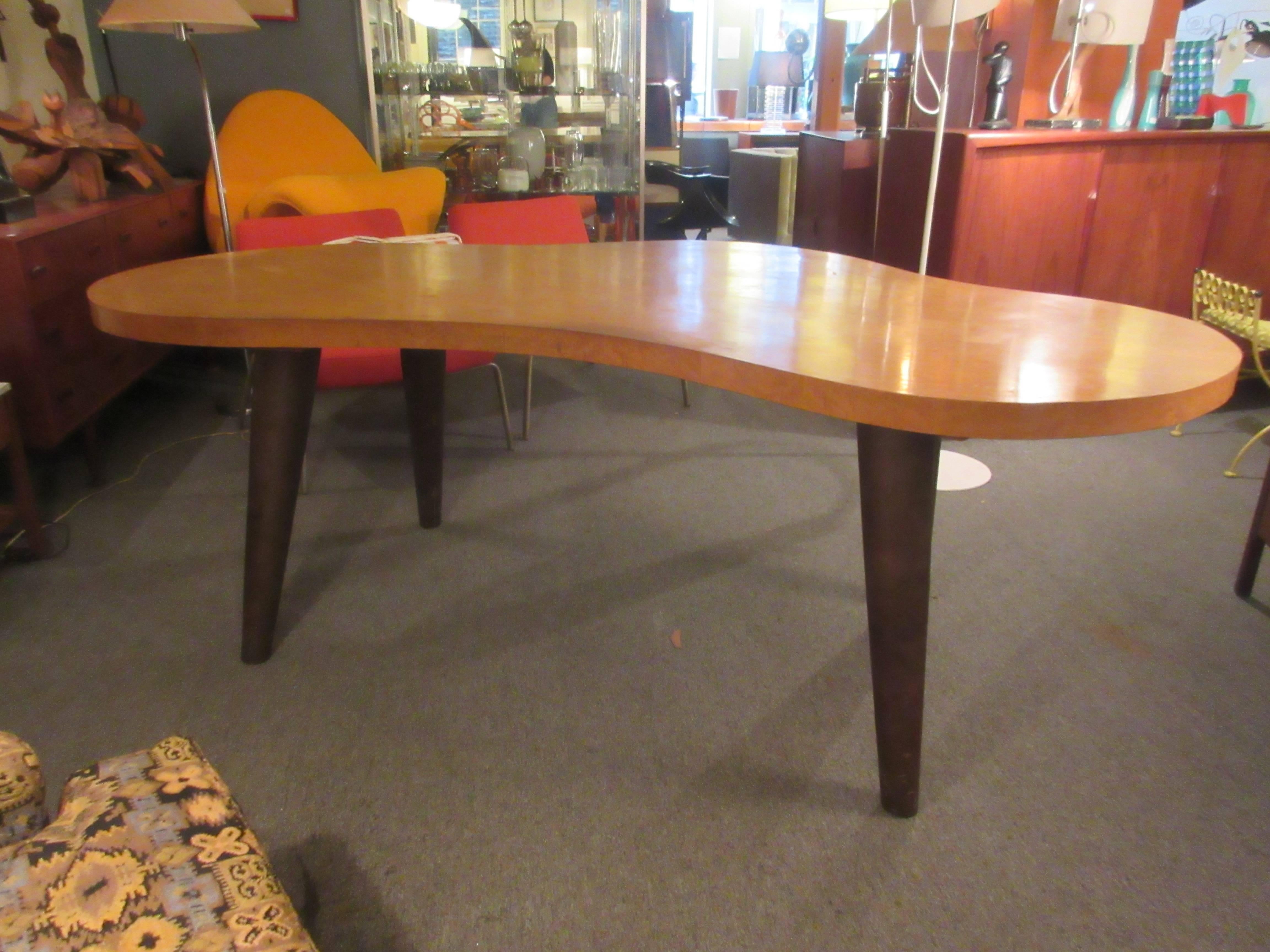 Massive Urban dining table or desk as you wish. Top is a bird's-eye maple and conical legs are covered in deep chocolate leather. Table or desk is all original and in great condition. Would seat eight as a dining table. Legs detach for shipping if