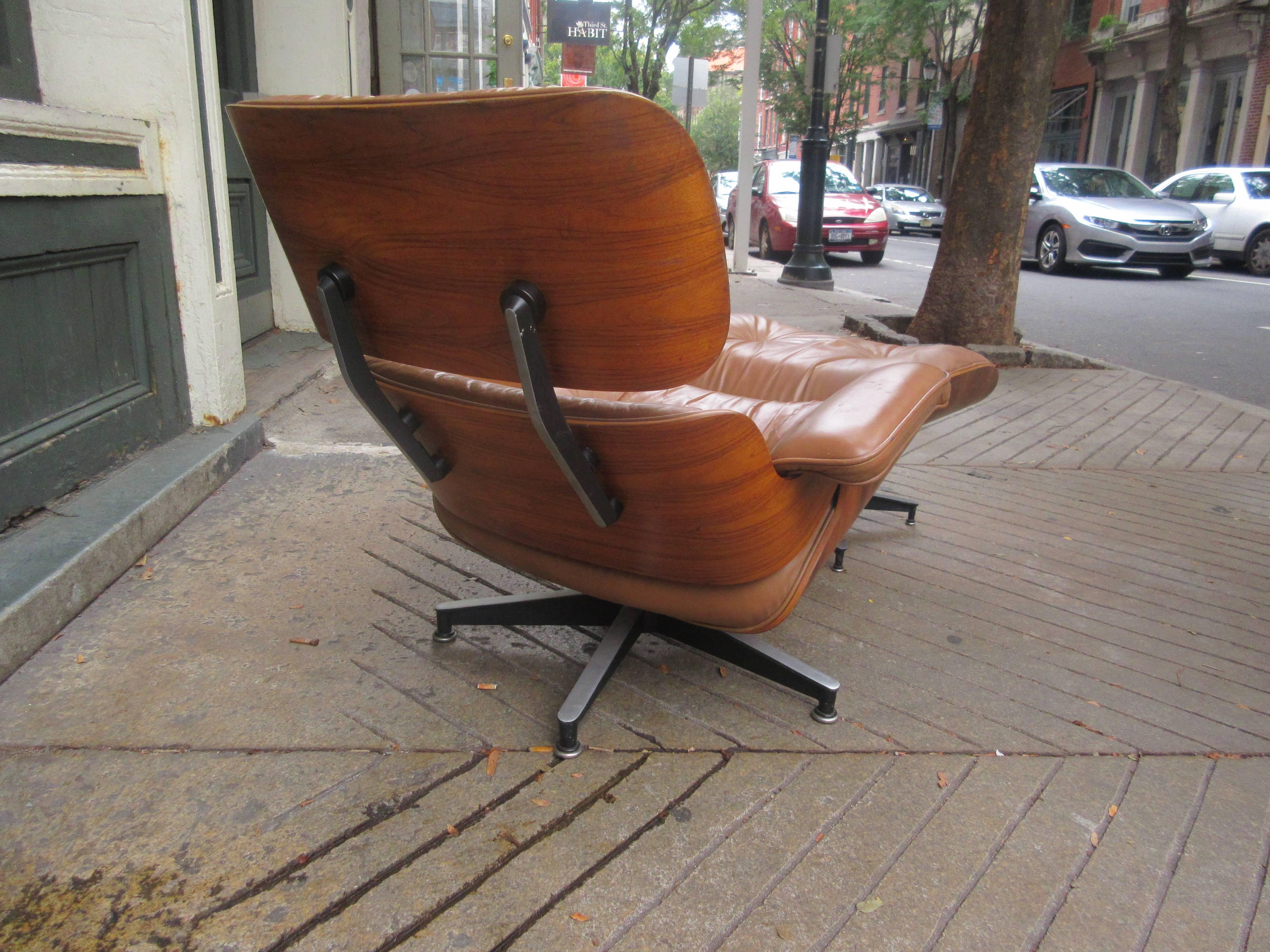 Eames 670/71 rosewood lounger in tan leather. This is a late 1960s edition. Both chair and ottoman retain Herman Miller tags. A crack on the lower back support has been expertly repairs and is structurally sound. (Pictured)   