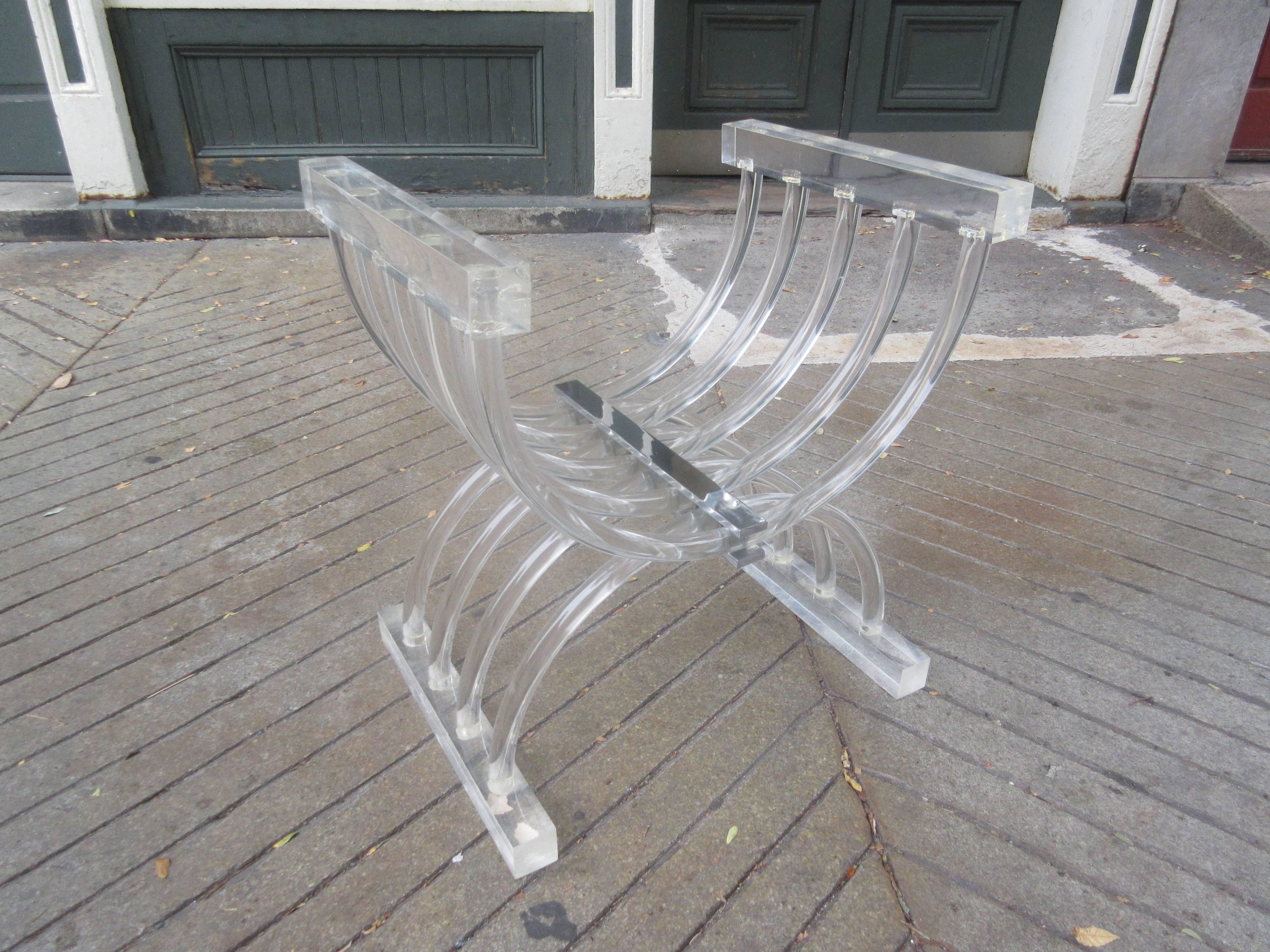 Very uncommon Lucite bench! Can be used with a vanity or as a stool! Heavy Lucite arms and sled runner feet connect with criss-crossing tubular Lucite! All held together with a centre chrome support! Cushion fabric has seen it's better day, but