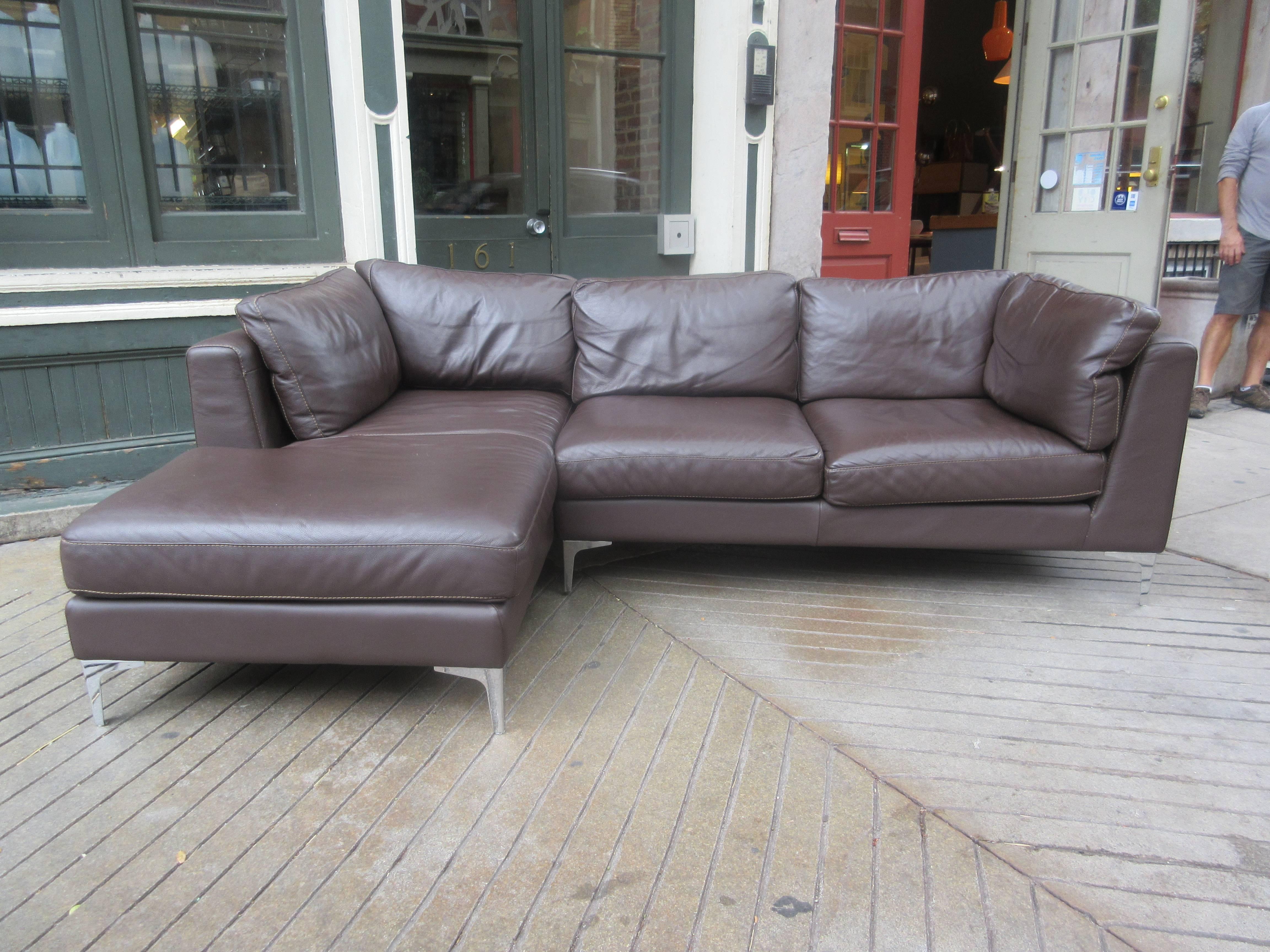 An in house design sectional from DWR in a supple milk chocolate leather. May be used as a single L shaped unit or separate. Chrome legs provide the supports, cushions are Velcroed fast so as not to slip out of place. Label remains.